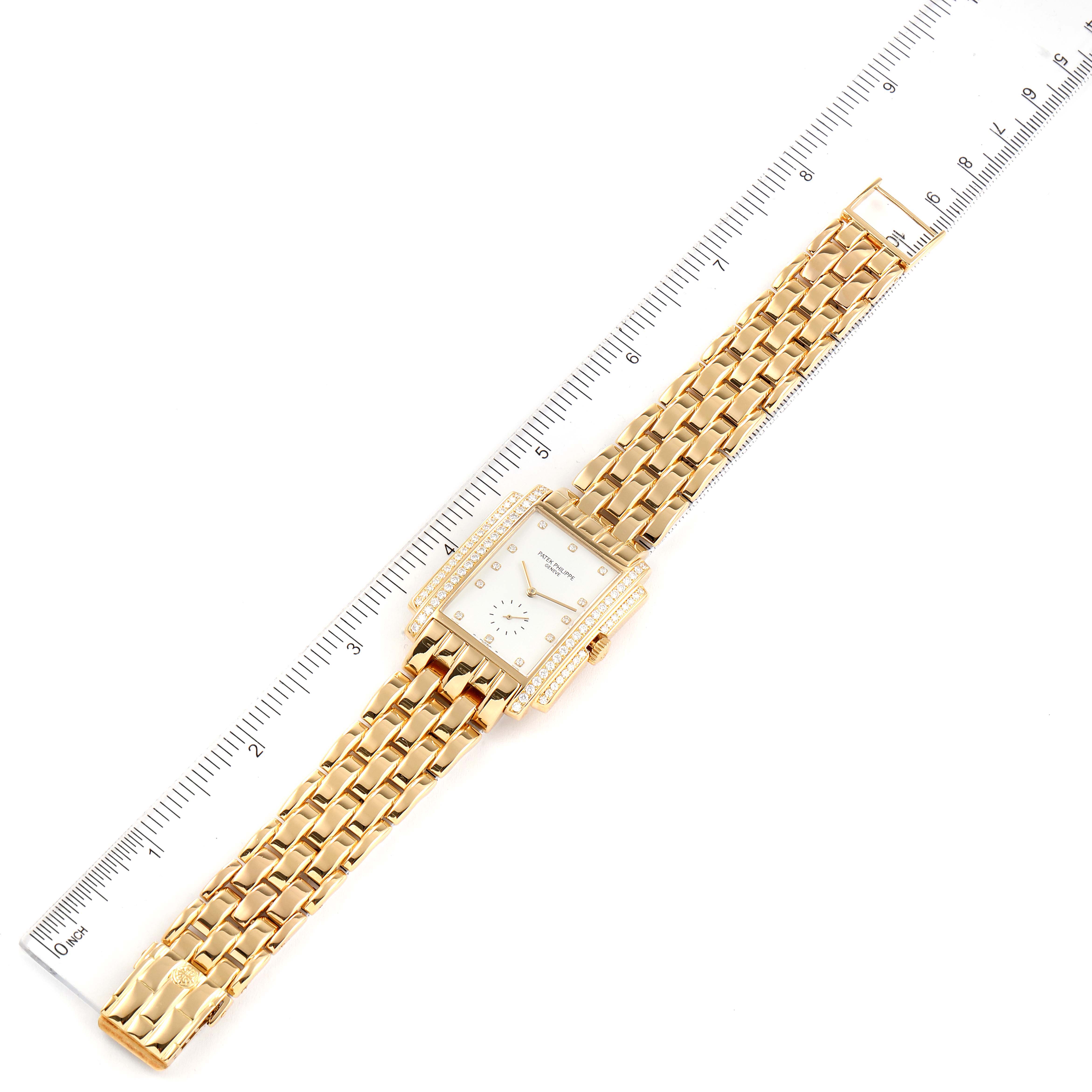 The image shows a Patek Philippe Gondolo 5025J Men
s Yellow Gold White Dial 5025J Men
s Yellow Gold White Dial watch lying flat with a ruler beside it for scale.