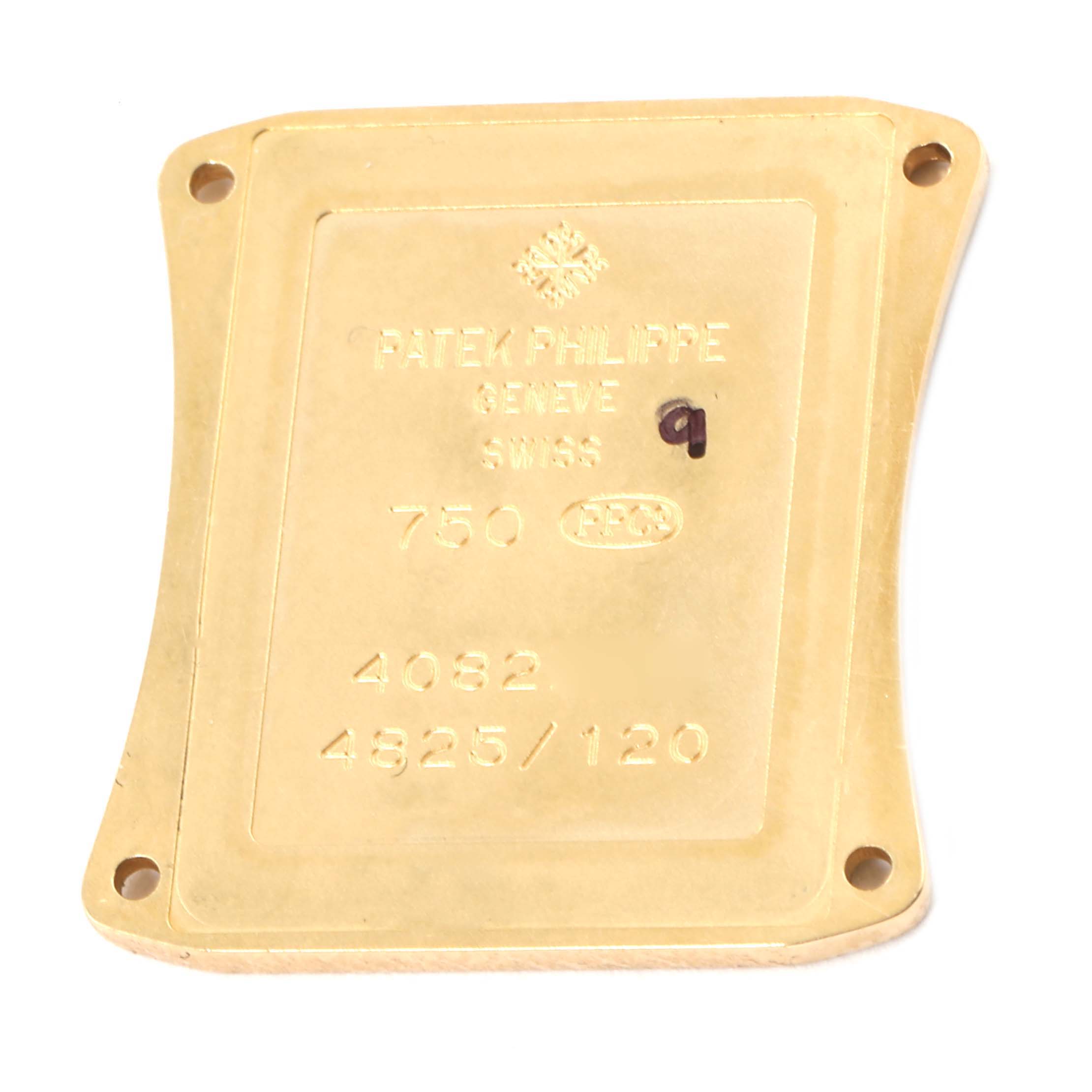 The image shows the back plate of a Patek Philippe Gondolo 4825J Women's Yellow Gold Mother of Pearl Dial 4825J Women's Yellow Gold Mother of Pearl Dial watch with engravings including the brand, gold purity, and model numbers.