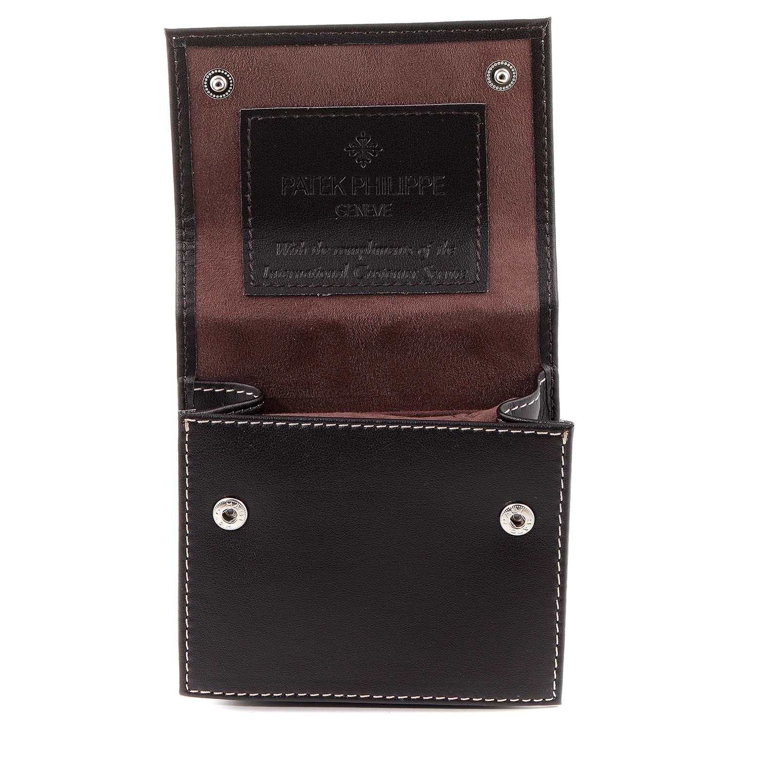 This image shows an open leather case for the Patek Philippe Twenty-4 4910/10A-010 Women's Stainless Steel Grey Dial 4910/10A-010 Women's Stainless Steel Grey Dial model watch, displaying its interior and brand imprint.