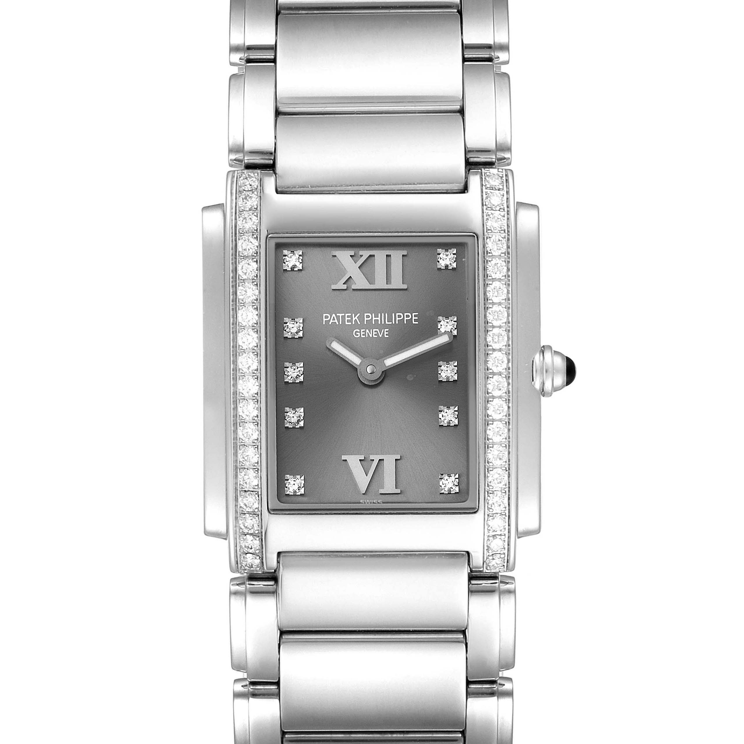 The image shows a front view of the Patek Philippe Twenty-4 4910/10A-010 Women's Stainless Steel Grey Dial 4910/10A-010 Women's Stainless Steel Grey Dial watch, highlighting its rectangular face and metallic bracelet.