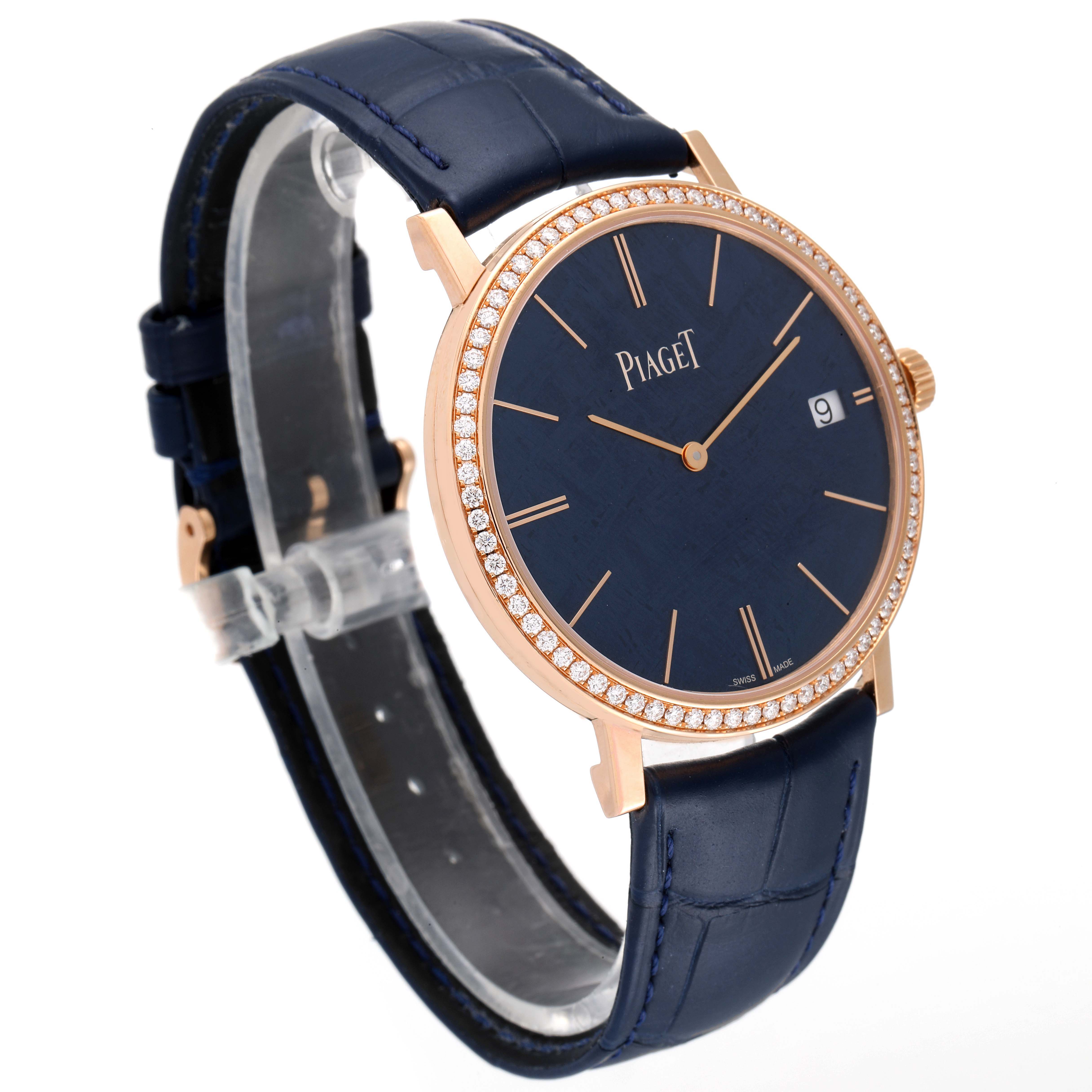 The Piaget G0A44052 Men's Rose Gold Blue Dial G0A44052 Men's Rose Gold Blue Dial Altiplano GOA44052 is shown at an angle that highlights the watch face, rose gold case, diamond bezel, and strap.