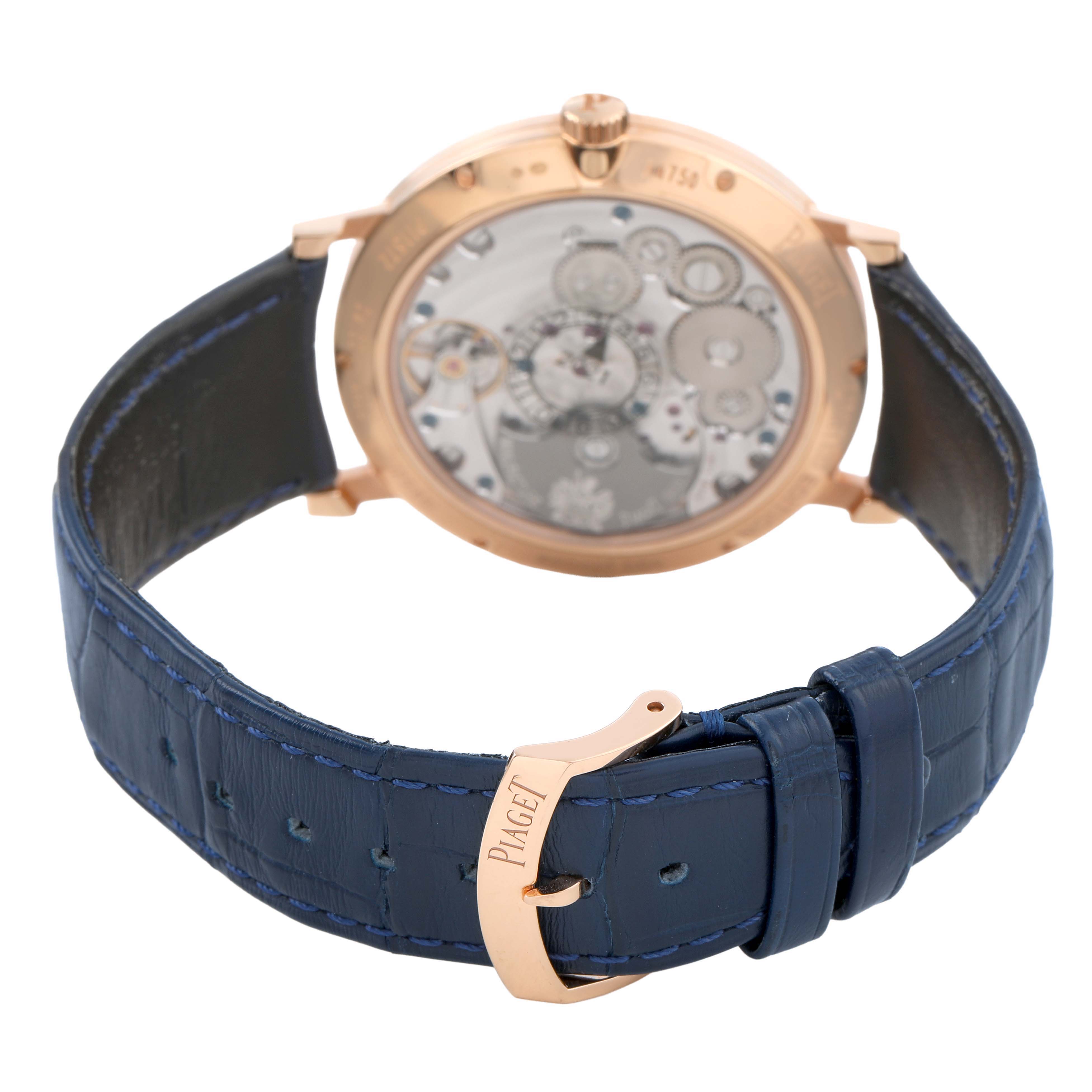 The Piaget G0A44052 Men's Rose Gold Blue Dial Altiplano GOA44052 is shown from the back, highlighting its movement and blue leather strap with a rose gold buckle.