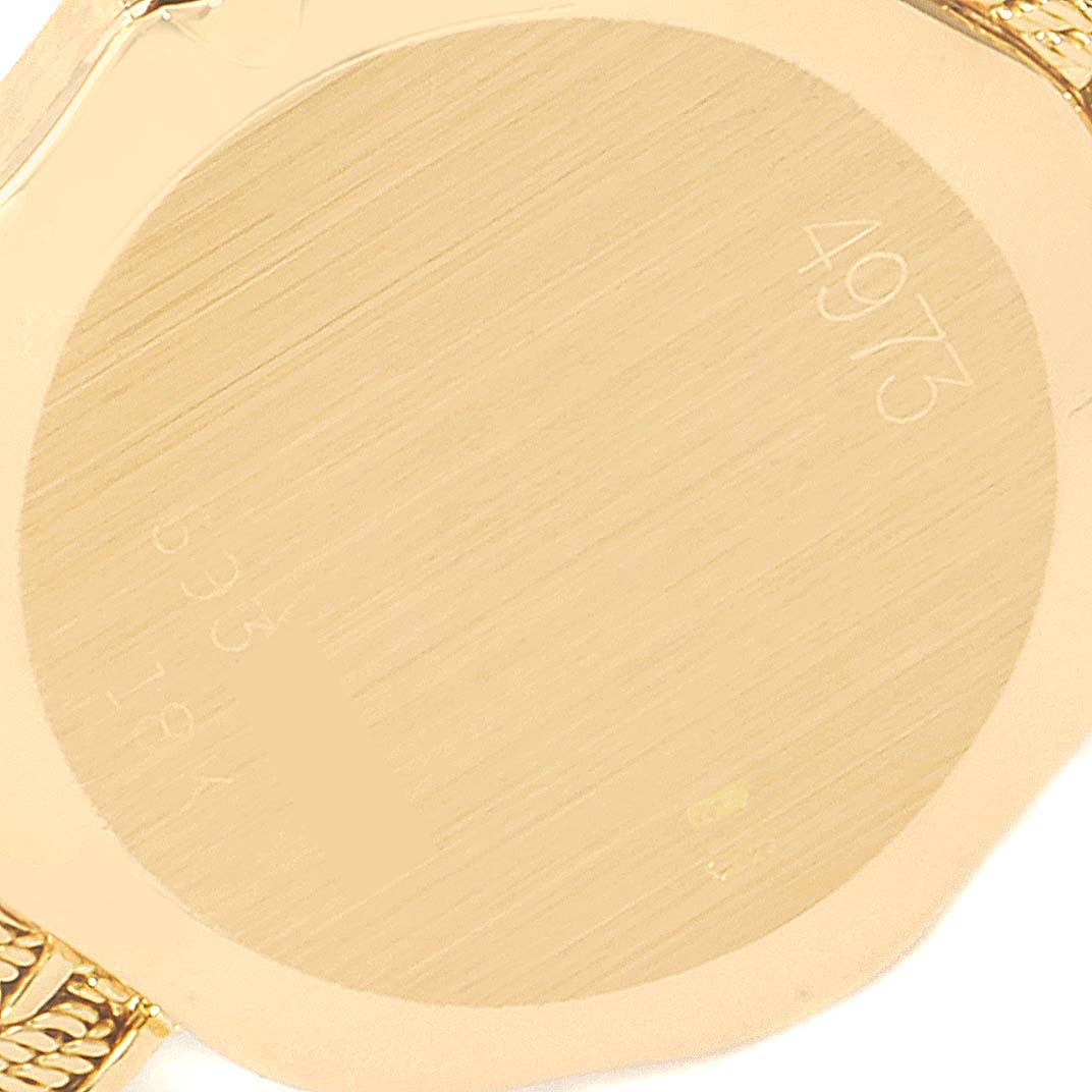 This image shows the back of the Rolex Cellini 4973 Women's Yellow Gold Champagne Dial 4973 Women's Yellow Gold Champagne Dial watch, highlighting its gold-toned case and engraved numbers.