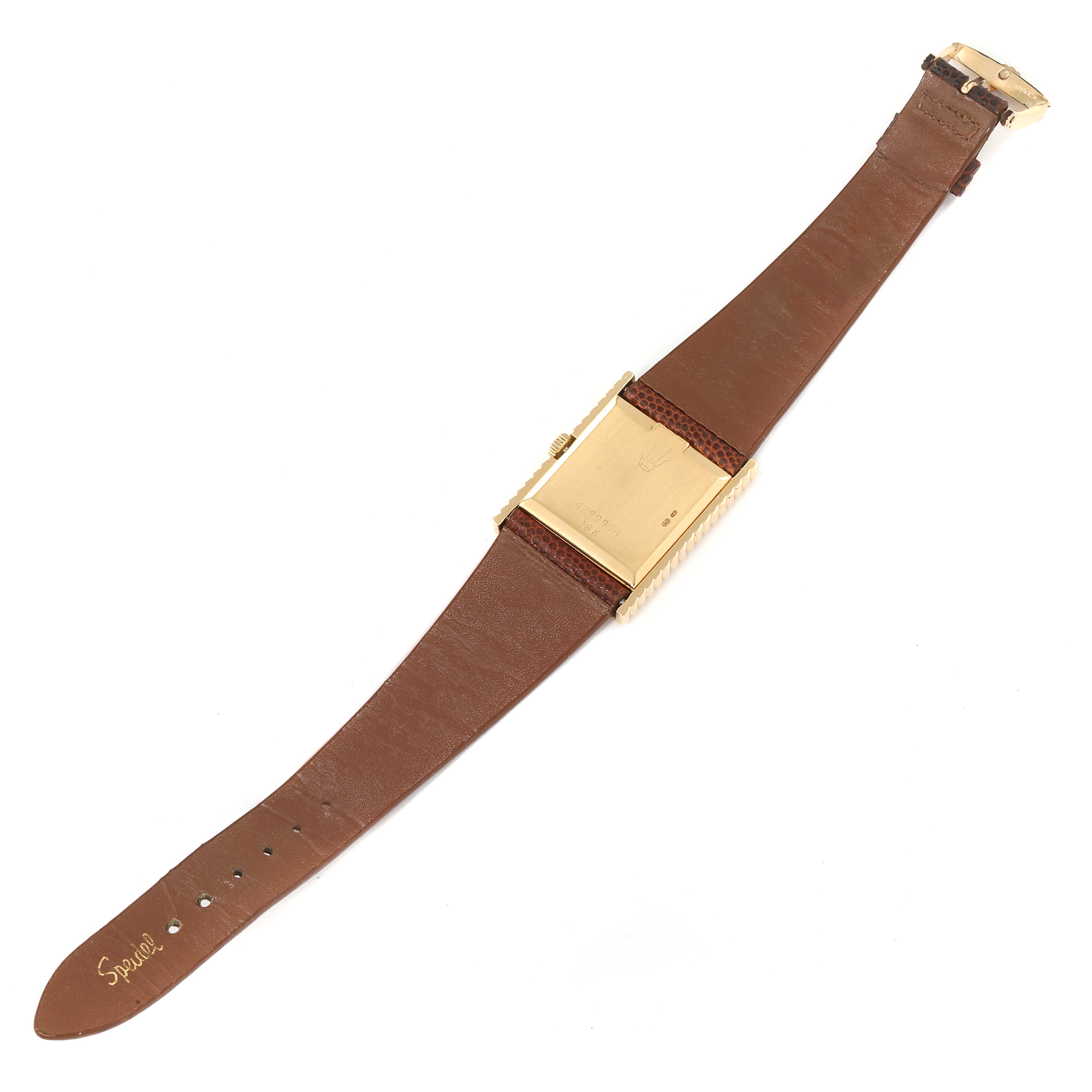 The image shows the back and strap of a Rolex Cellini 4012 Men's Yellow Gold Champagne Dial 4012 Men's Yellow Gold Champagne Dial watch, featuring a gold case and a brown leather band.