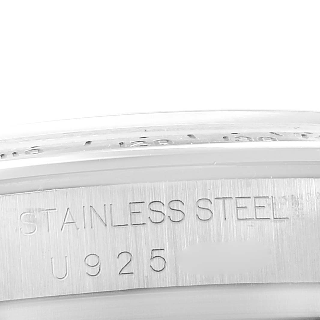 The image shows a close-up angle of the stainless steel part of a Rolex Daytona 16520 Men's Stainless Steel Black Dial 16520 Men's Stainless Steel Black Dial watch, highlighting the metal's engraving.