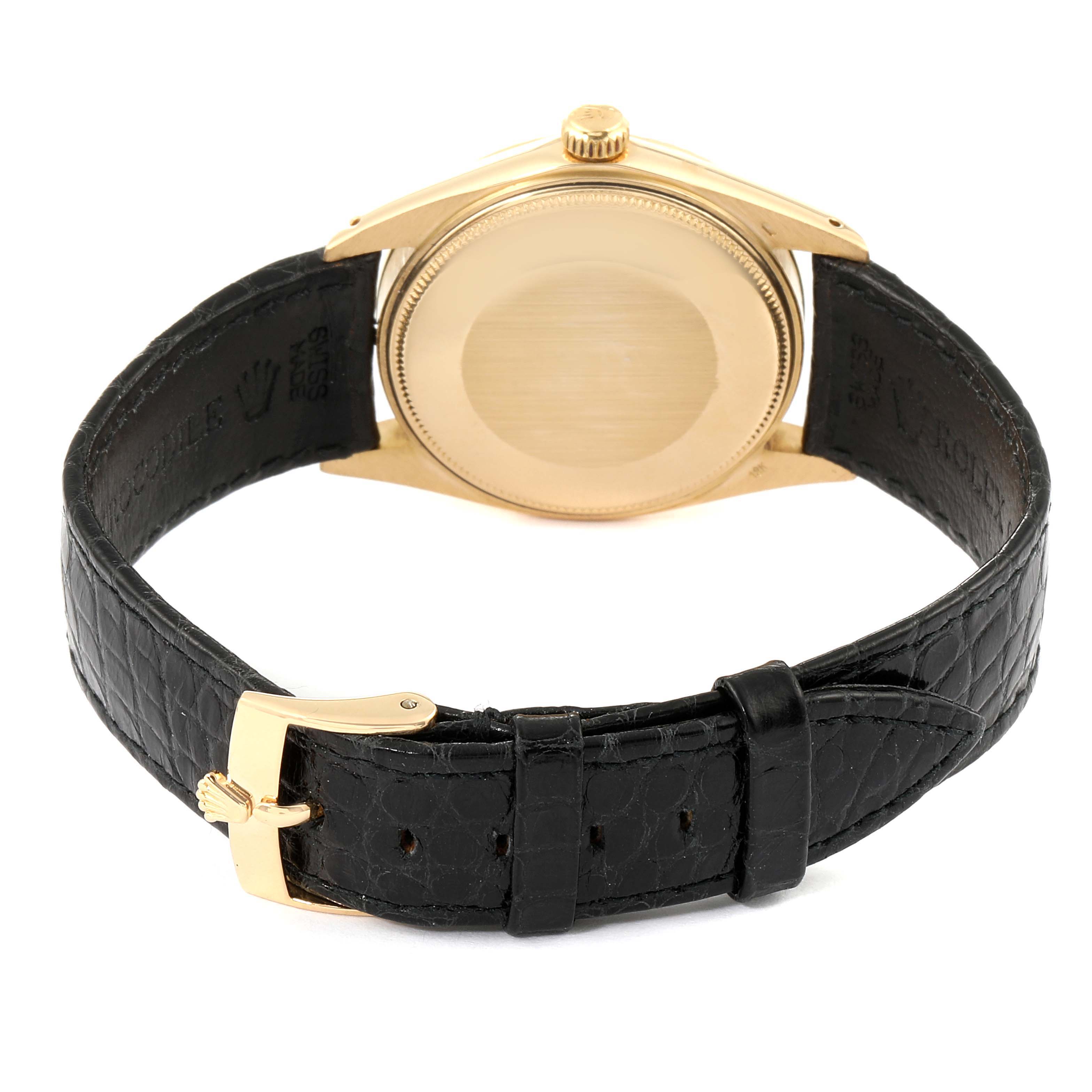 The photo shows the back of the Rolex Vintage Collection 1503 Men's Yellow Gold Champagne Dial 1503 Men's Yellow Gold Champagne Dial watch, including the case back, crown, and black leather strap with a gold buckle.