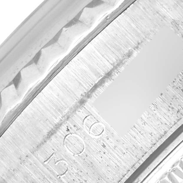The image shows a close-up angle of the edge of a Rolex Date 6917 Women's Stainless Steel Blue Dial 6917 Women's Stainless Steel Blue Dial watch, highlighting the engraved details on its surface.