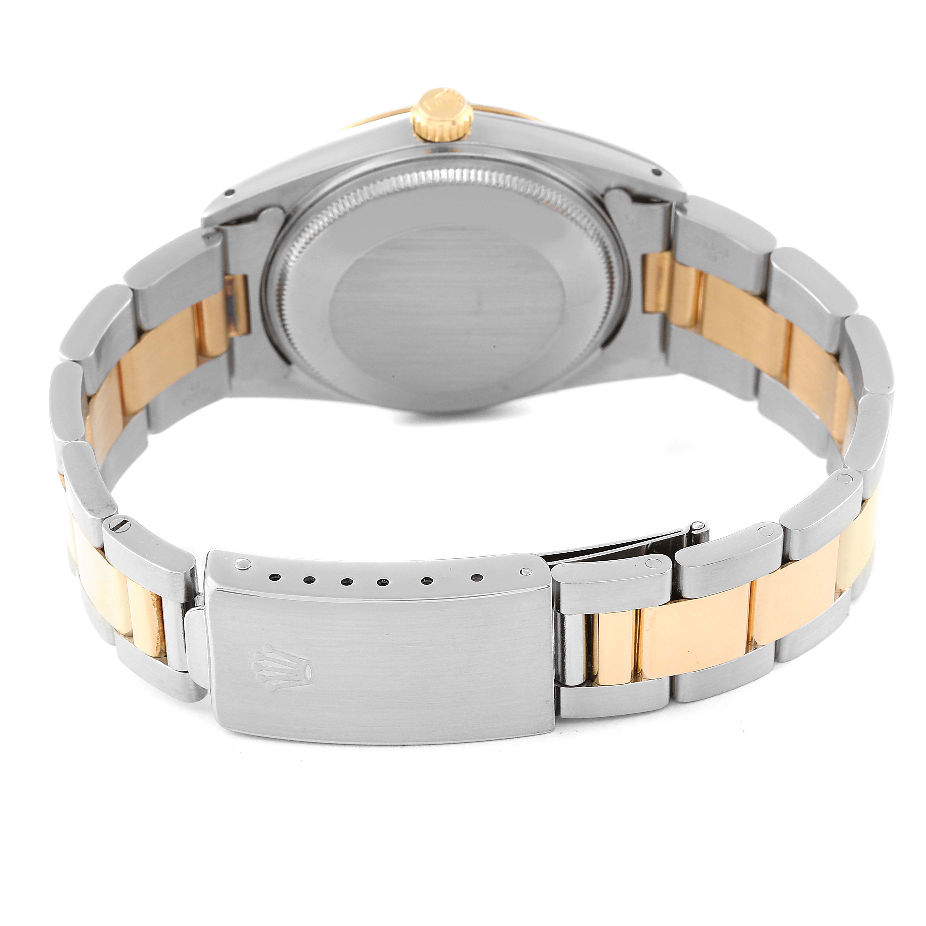 The image shows the back view of a Rolex Date 15053 Men
s Steel and Gold (two tone) Champagne Dial 15053 Men
s Steel and Gold (two tone) Champagne Dial watch, highlighting the clasp and bracelet.