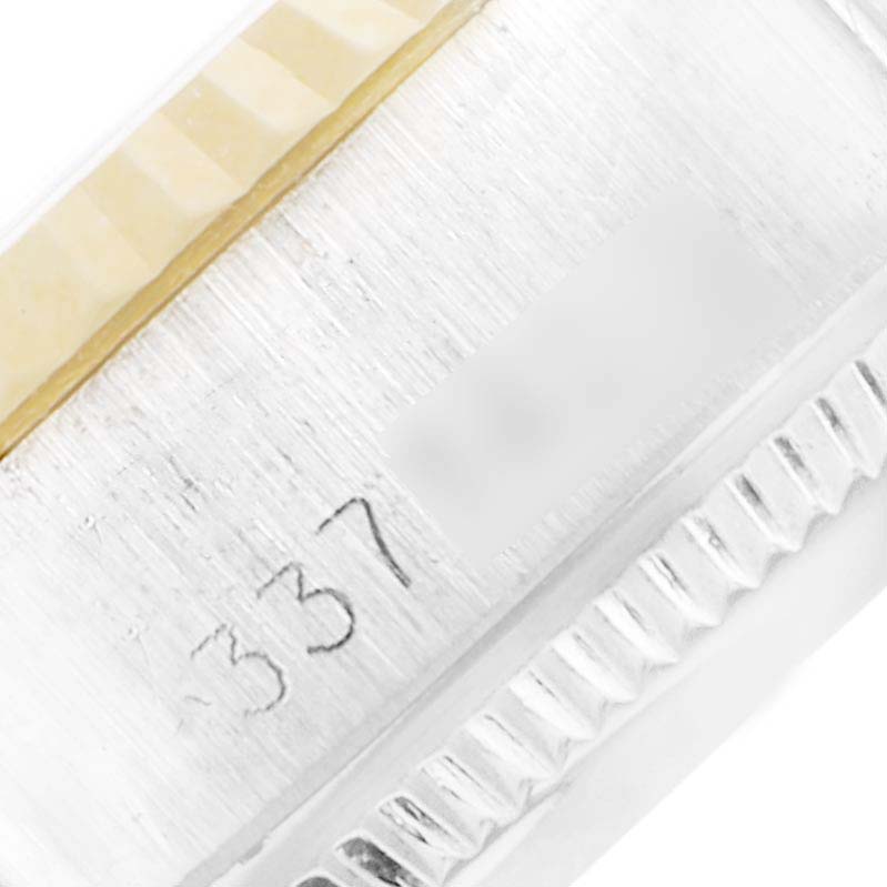 This close-up image of a Rolex Date 6917 Women's Steel and Gold (two tone) Champagne Dial 6917 Women's Steel and Gold (two tone) Champagne Dial model shows part of the case back with an engraved number.