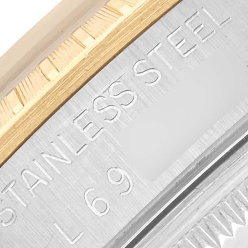 The image shows a close-up of the Rolex Date 15223 Men's Steel and Gold (two tone) Silver Dial 15223 Men's Steel and Gold (two tone) Silver Dial model's bezel and case, highlighting the stainless steel and gold detailing.