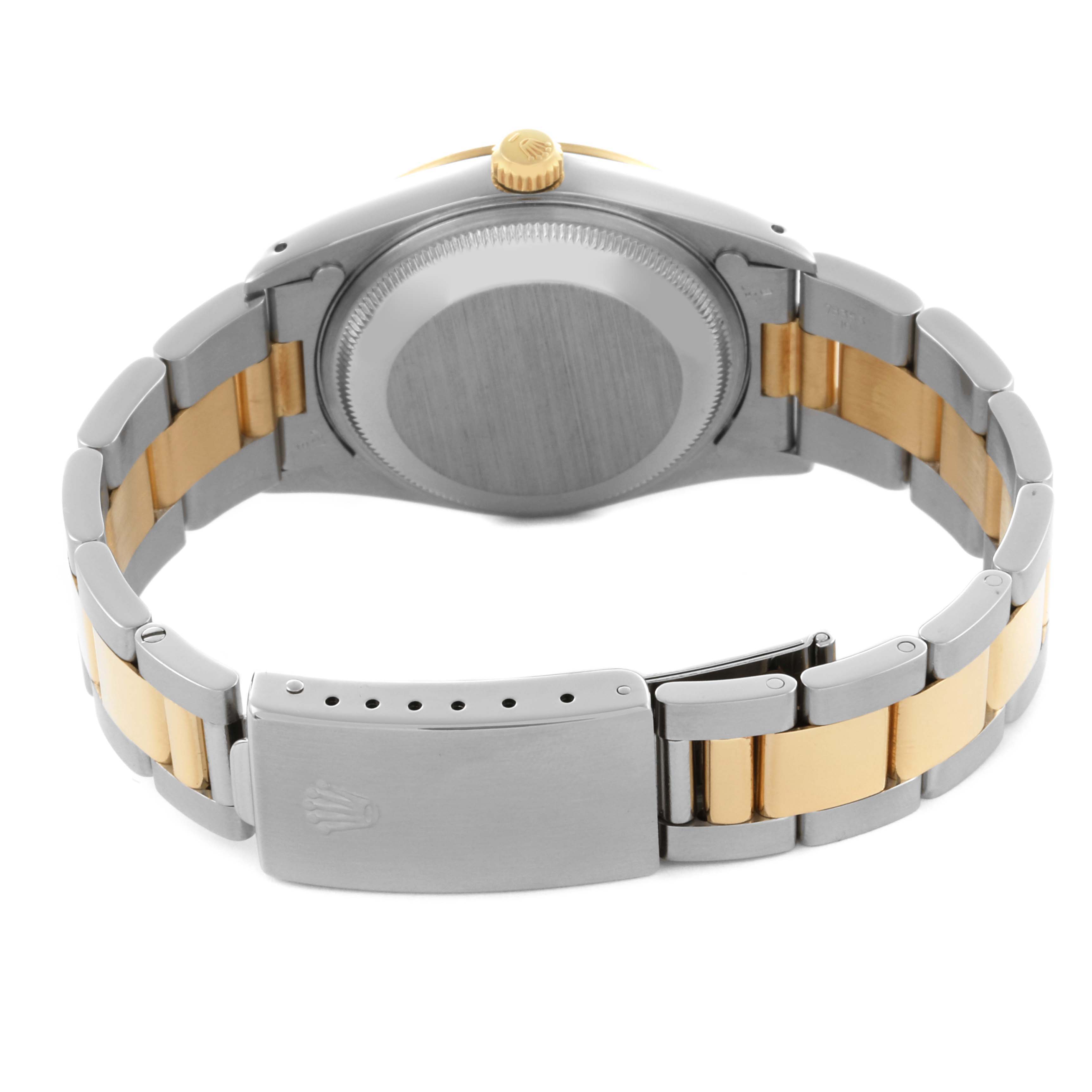 The Rolex Date 15223 Men's Steel and Gold (two tone) Silver Dial 15223 Men's Steel and Gold (two tone) Silver Dial watch is shown from the back, displaying the stainless steel and gold bracelet and the clasp.