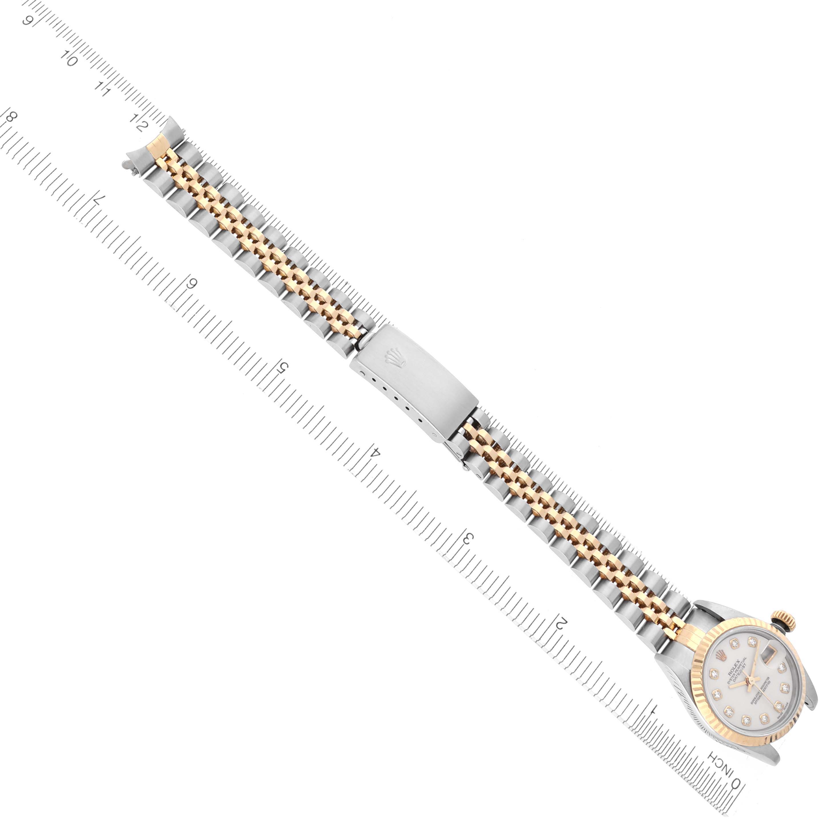 The image shows a Rolex Datejust 69173 Women's Steel and Gold (two tone) White Dial 69173 Women's Steel and Gold (two tone) White Dial watch laid flat, displaying the dial, case, and entire bracelet with a measuring tool alongside.
