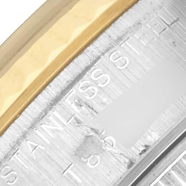 The image shows a close-up of the bezel and engraved writing on a Rolex Datejust 69173 Women's Steel and Gold (two tone) White Dial 69173 Women's Steel and Gold (two tone) White Dial, highlighting its stainless steel and gold elements.