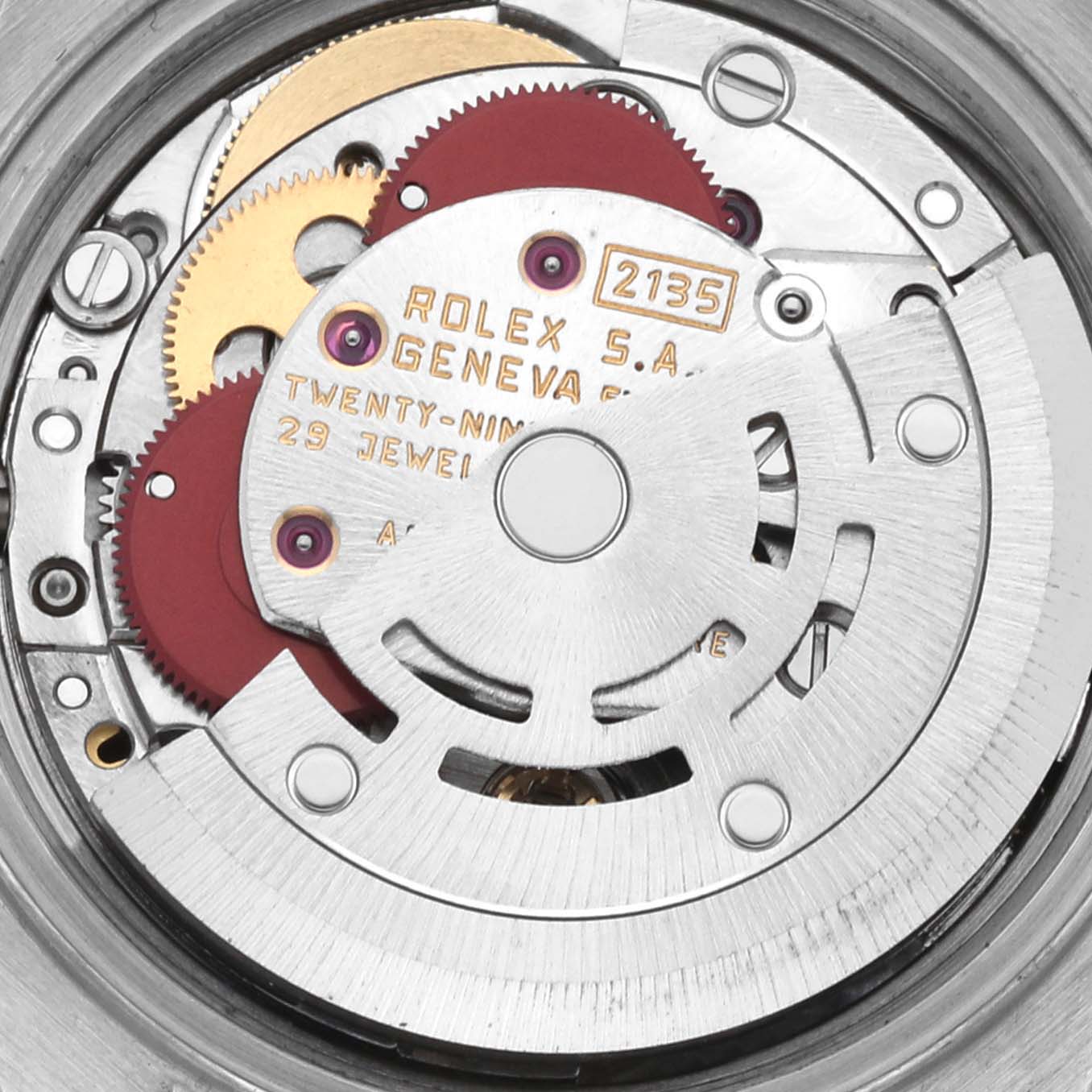 The image shows the inner mechanism of a Rolex Datejust 69173 Women's Steel and Gold (two tone) White Dial 69173 Women's Steel and Gold (two tone) White Dial watch, highlighting its gears and rotor from a close-up angle.
