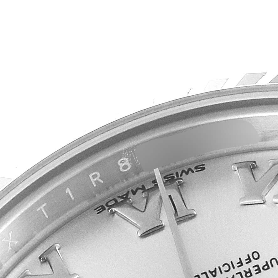 This close-up image of a Rolex Datejust 279174 Women's Stainless Steel Silver Dial 279174 Women's Stainless Steel Silver Dial watch shows part of the dial, hour markers, and edge of the bezel.