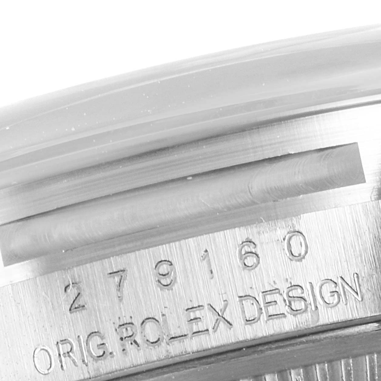 This close-up image shows the side of a Rolex Datejust 279160 Women's Stainless Steel White Dial 279160 Women's Stainless Steel White Dial model, focusing on the engraved serial number and "ORIG. ROLEX DESIGN."
