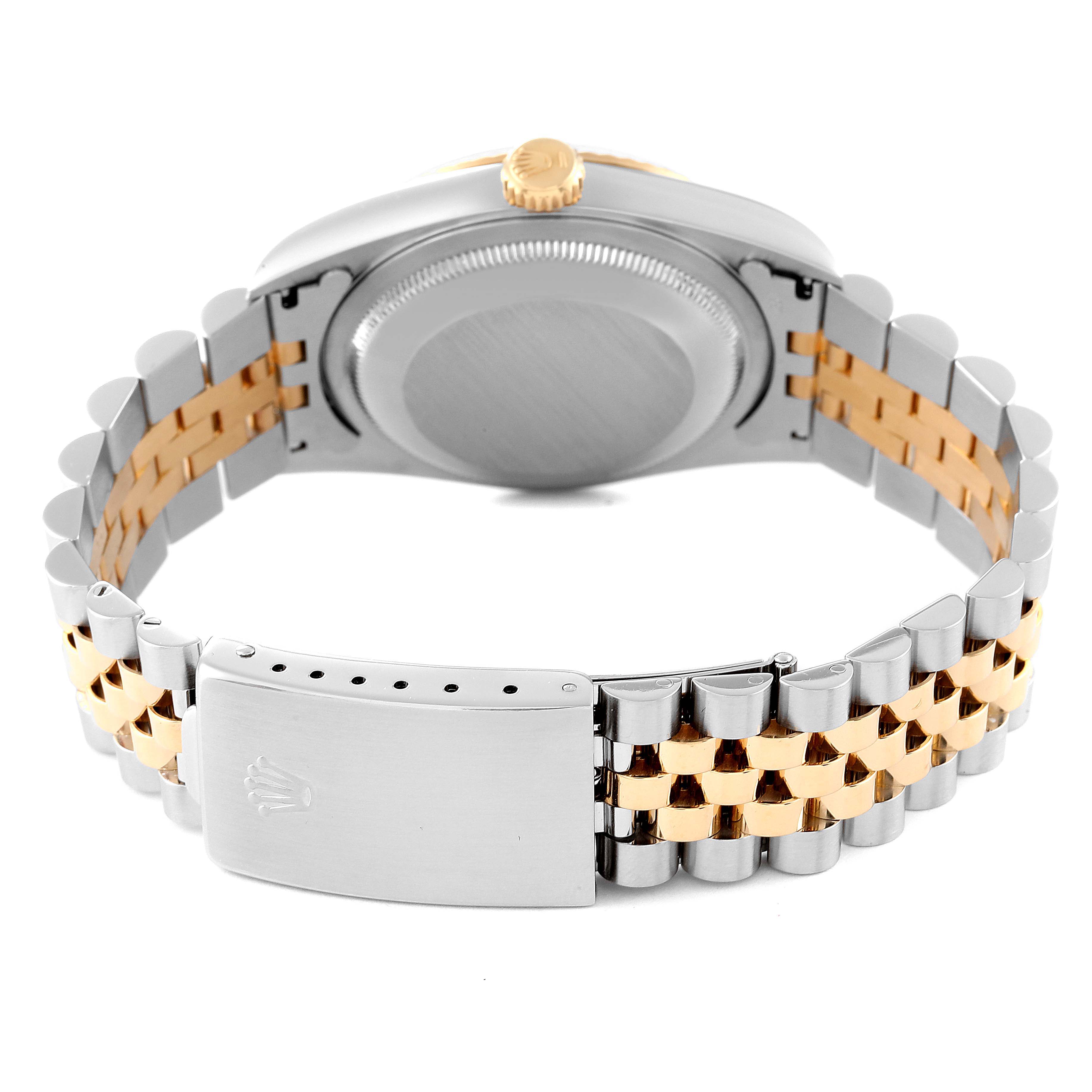 The image shows the back of a Rolex Datejust 16233 Men's Steel and Gold (two tone) Blue Dial 16233 Men's Steel and Gold (two tone) Blue Dial watch, highlighting the case, crown, and two-tone bracelet.