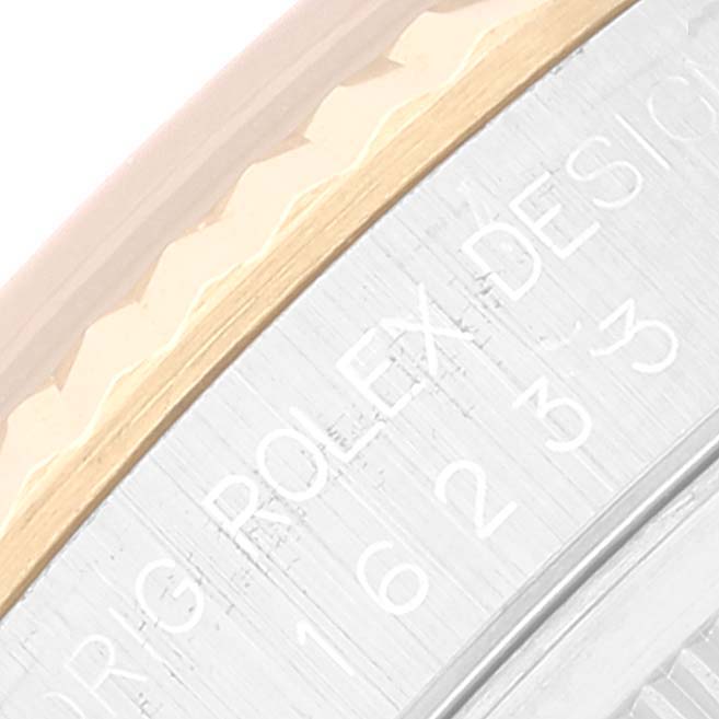This close-up image shows the engraved bezel and edge of the dial of a Rolex Datejust 16233 Men's Steel and Gold (two tone) Blue Dial 16233 Men's Steel and Gold (two tone) Blue Dial watch.
