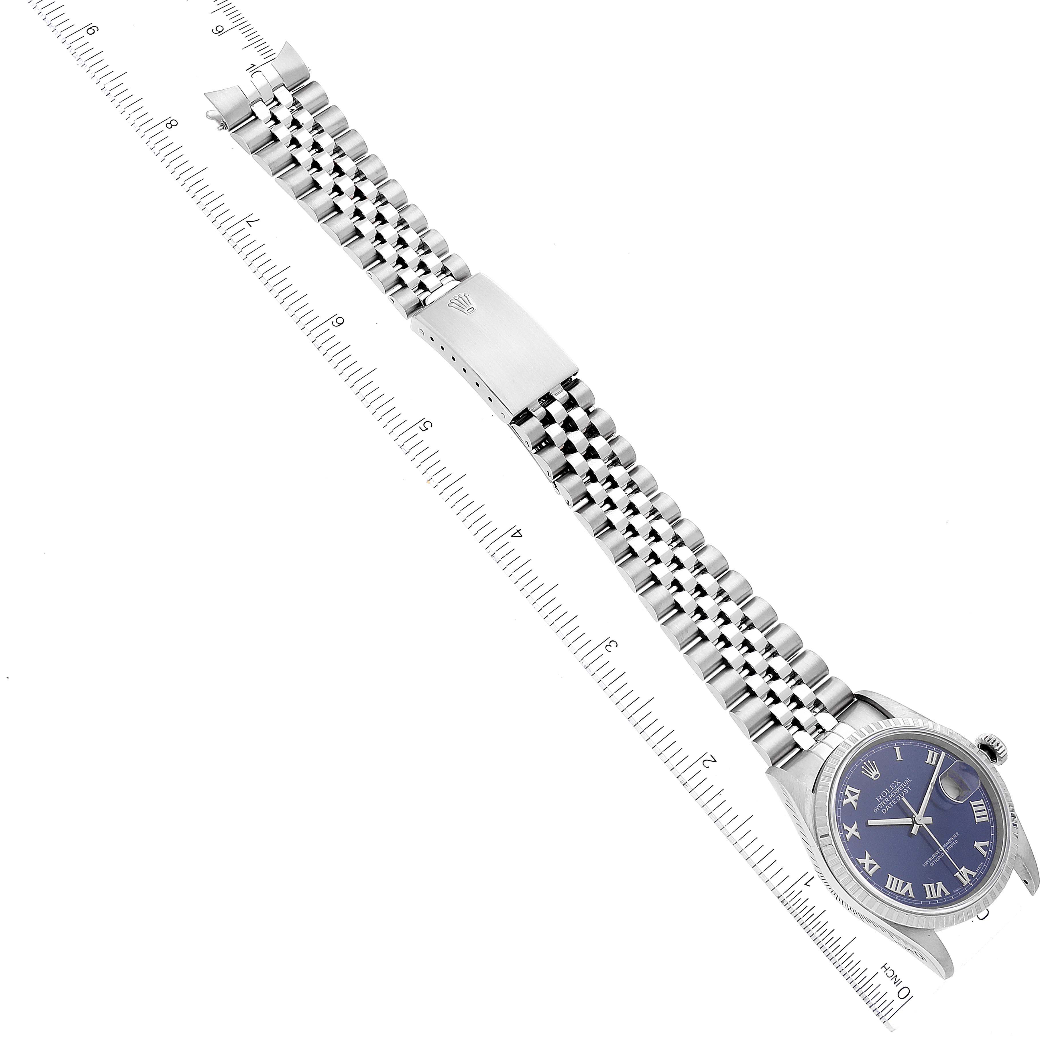 The image shows a Rolex Datejust 16220 Men's Stainless Steel Blue Dial 16220 Men's Stainless Steel Blue Dial watch, including its dial, bezel, and full bracelet, displayed next to a ruler.