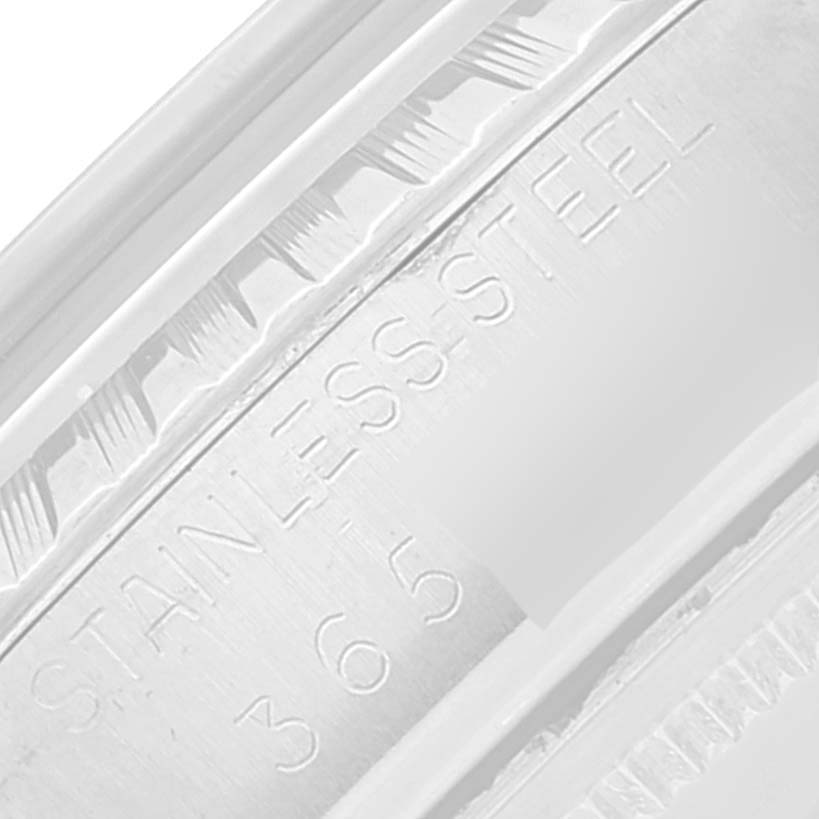 This close-up of a Rolex Vintage Collection 1603 Men's Stainless Steel Silver Dial 1603 Men's Stainless Steel Silver Dial watch shows the "STAINLESS STEEL" engraving on the case.