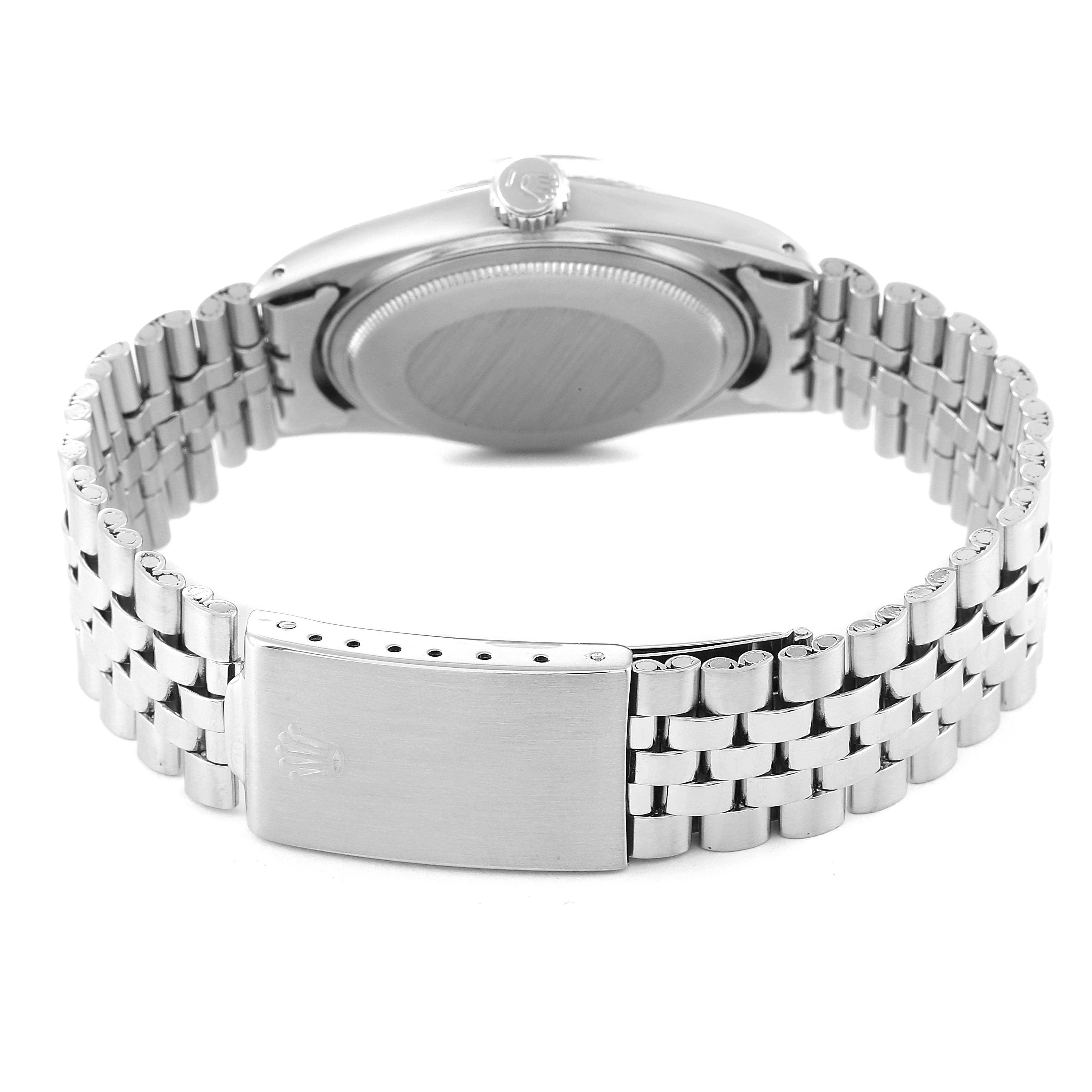 The image shows the back view of a Vintage Collection Rolex watch, focusing on the case back, crown, and metal bracelet.