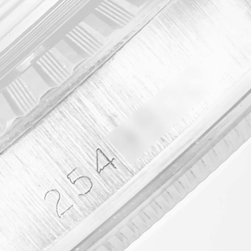 The image shows a close-up angle of the serial number engraving on the case of a Vintage Collection model by Rolex.