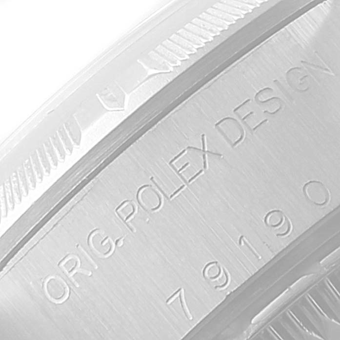 The image shows a close-up of the side casing engravings on a Rolex Date 79190 Women's Stainless Steel Silver Dial 79190 Women's Stainless Steel Silver Dial model watch.