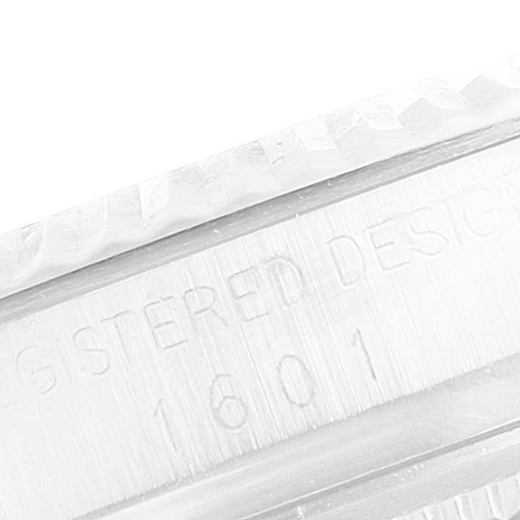 This close-up image shows the engraved model number "1601" on the bezel edge of a Rolex Vintage Collection 1601 Men's Stainless Steel Silver Dial 1601 Men's Stainless Steel Silver Dial watch.