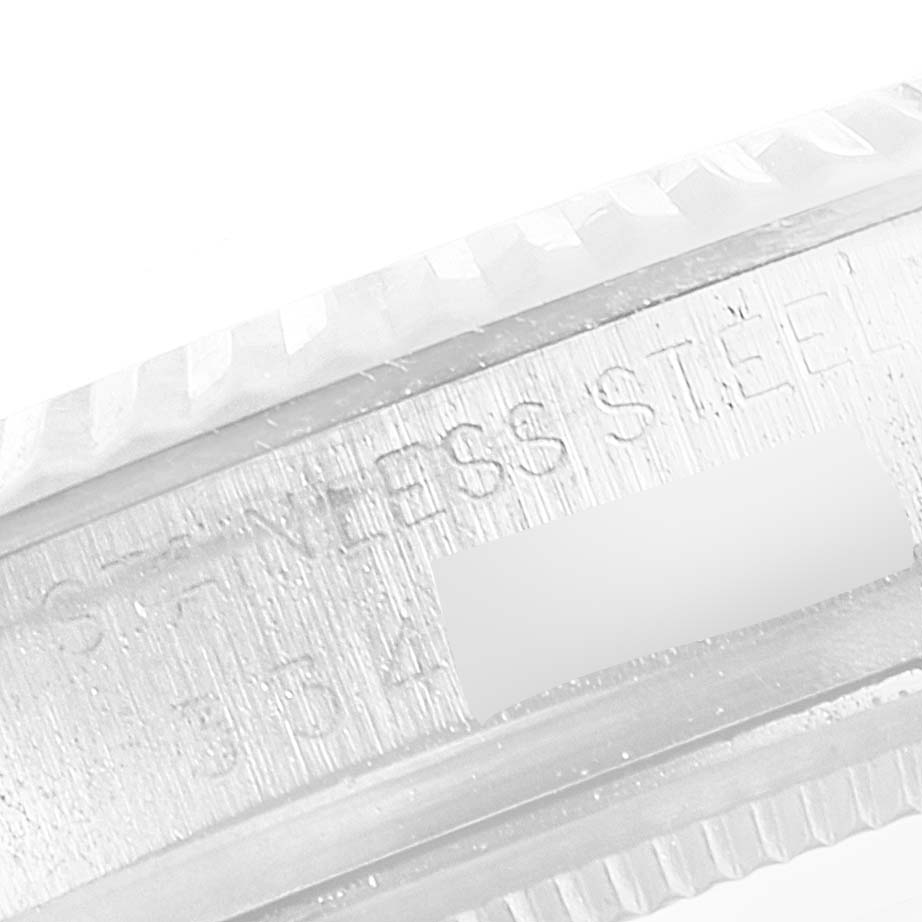 The image shows a close-up of the stainless steel bezel of a Vintage Collection Rolex watch.