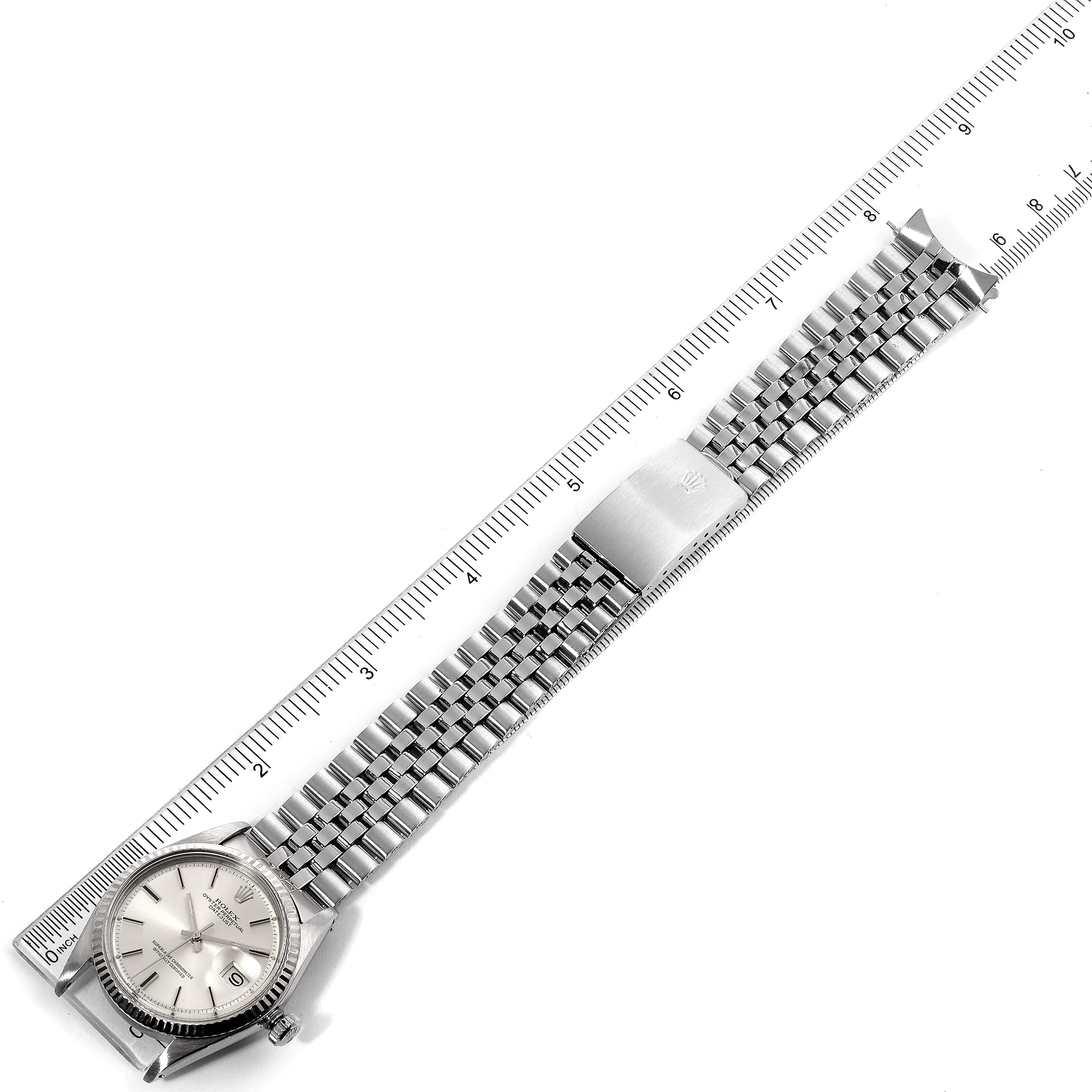 The image shows a top-down view of a Rolex Vintage Collection 1601 Men's Stainless Steel Silver Dial 1601 Men's Stainless Steel Silver Dial watch, including the full face and metal bracelet next to a ruler for scale.
