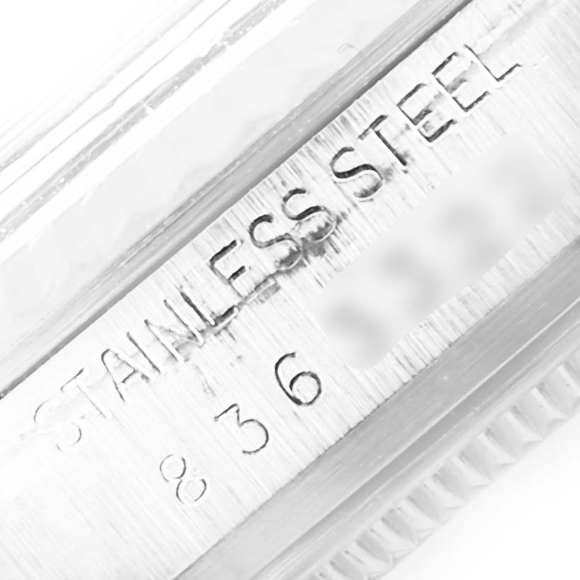 This image shows a close-up of the case side of a Rolex Vintage Collection 16014 Men
s Stainless Steel Silver Dial 16014 Men
s Stainless Steel Silver Dial model watch, highlighting the "STAINLESS STEEL" engraving.