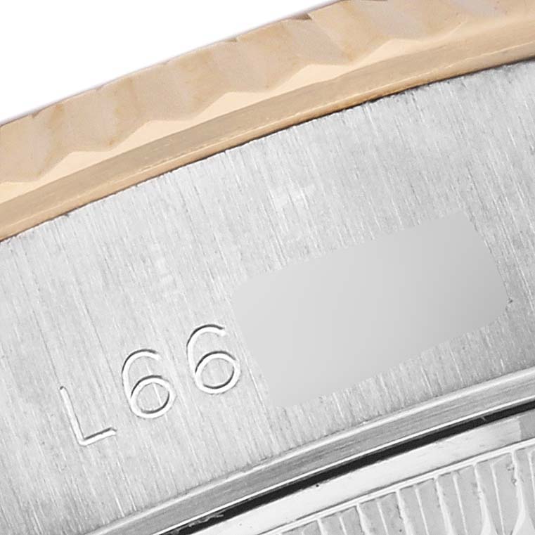 The image shows a close-up of the engraved case back edge and fluted bezel of a Rolex Datejust 69173 Women's Steel and Gold (two tone) Champagne Dial 69173 Women's Steel and Gold (two tone) Champagne Dial.