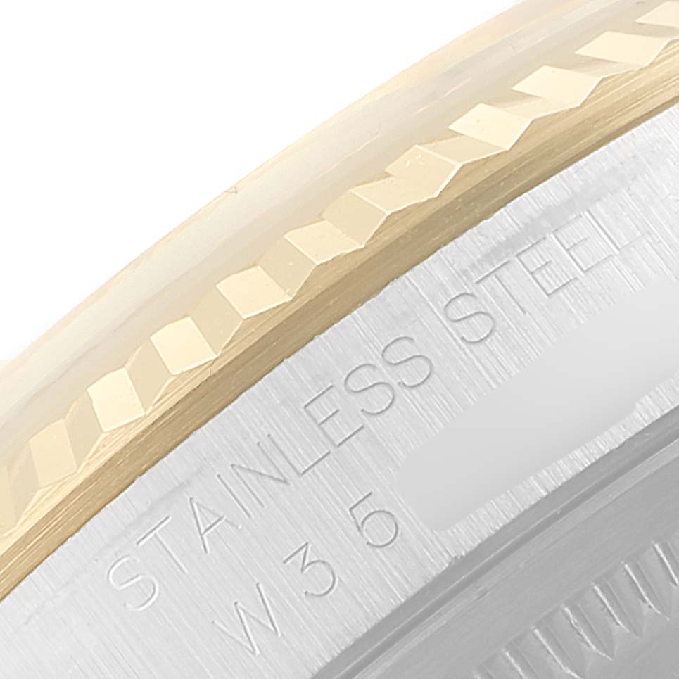 The image shows a close-up of the bezel and case edge of a Rolex Datejust 16233 Men
s Steel and Gold (two tone) Champagne Dial 16233 Men
s Steel and Gold (two tone) Champagne Dial watch, highlighting "STAINLESS STEEL" engraving.