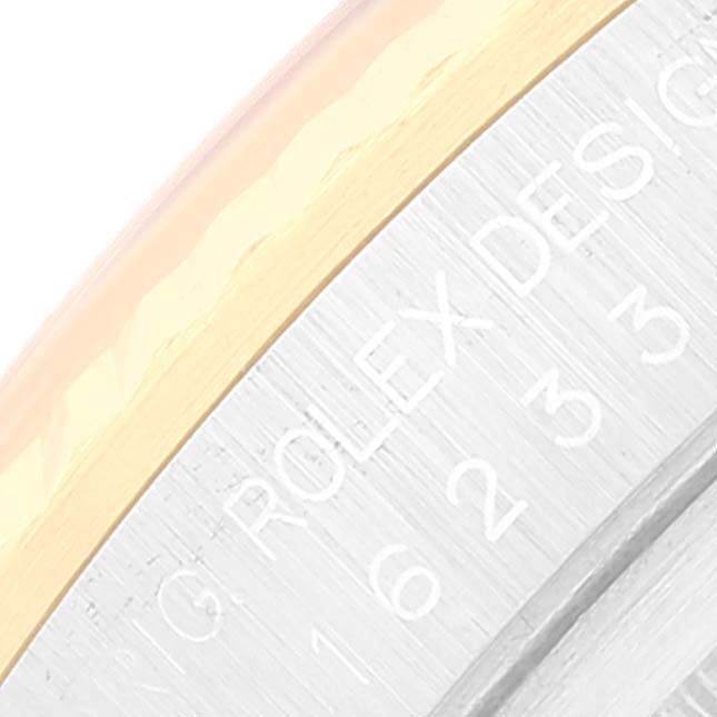 This close-up image shows the side of the bezel and the caseback engraving of a Rolex Datejust 16233 Men's Steel and Gold (two tone) Silver Dial 16233 Men's Steel and Gold (two tone) Silver Dial watch.