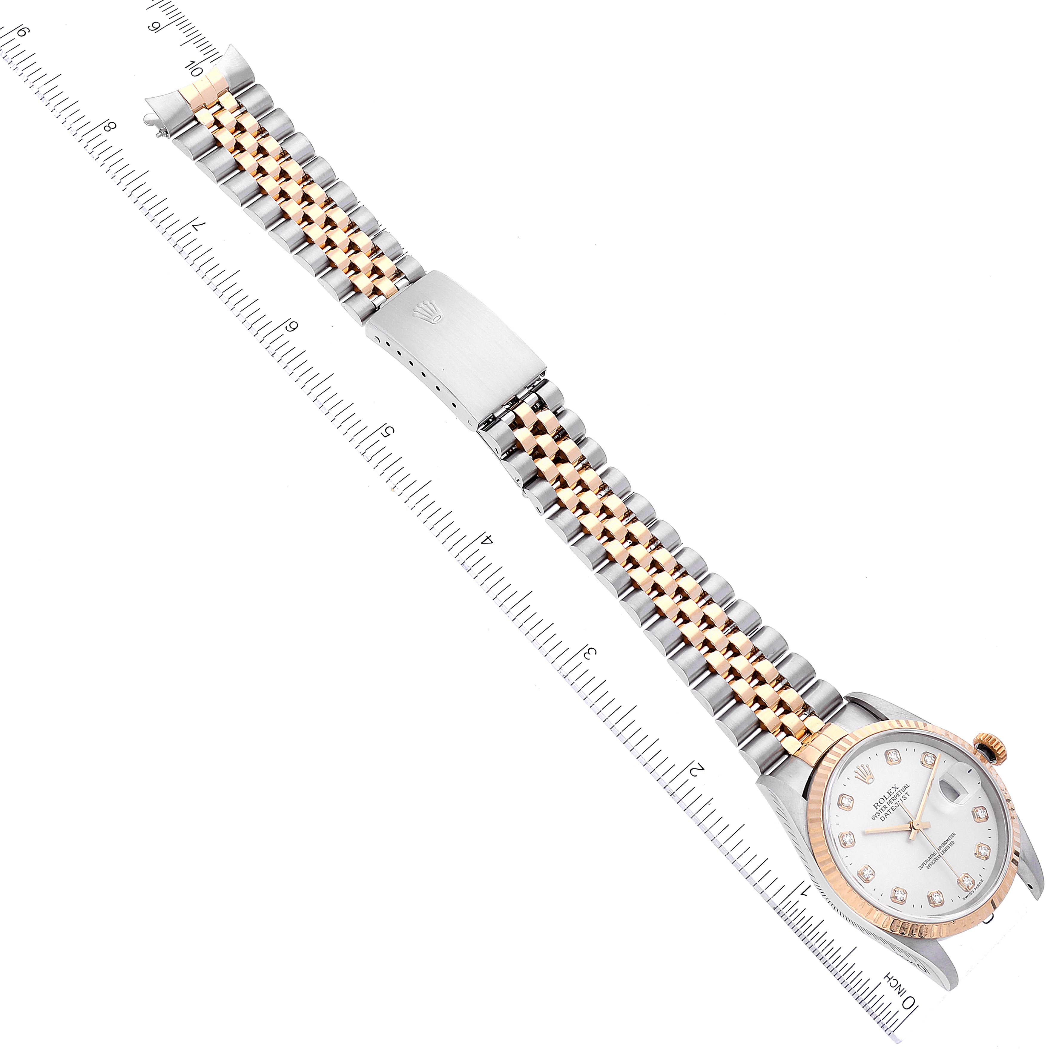 The Rolex Datejust 16233 Men's Steel and Gold (two tone) Silver Dial 16233 Men's Steel and Gold (two tone) Silver Dial watch is shown flat and fully extended, displaying the face, bracelet, clasp, and a ruler for measurement.