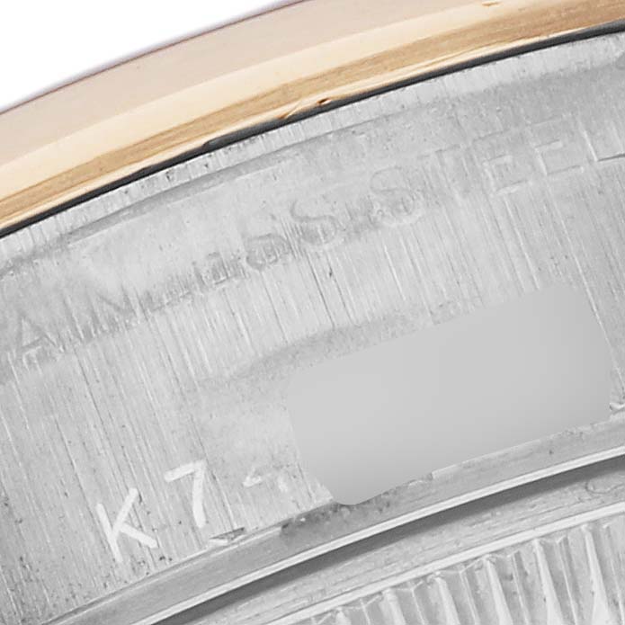 The image shows a close-up of the side of a Rolex Datejust 79163 Women's Steel and Gold (two tone) Grey Dial 79163 Women's Steel and Gold (two tone) Grey Dial, highlighting the engraved serial number and bezel edge.