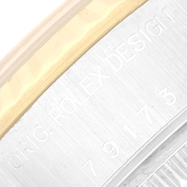This image shows a close-up angle of the casing edge of a Rolex Datejust 79173 Women's Steel and Gold (two tone) White Dial 79173 Women's Steel and Gold (two tone) White Dial watch, displaying its model and serial numbers.