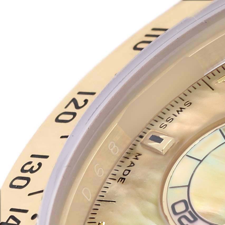 The image shows a close-up of the bezel and part of the dial of a Rolex Daytona 116528 Men's Yellow Gold Mother of Pearl Dial, highlighting the tachymetric scale and indices.