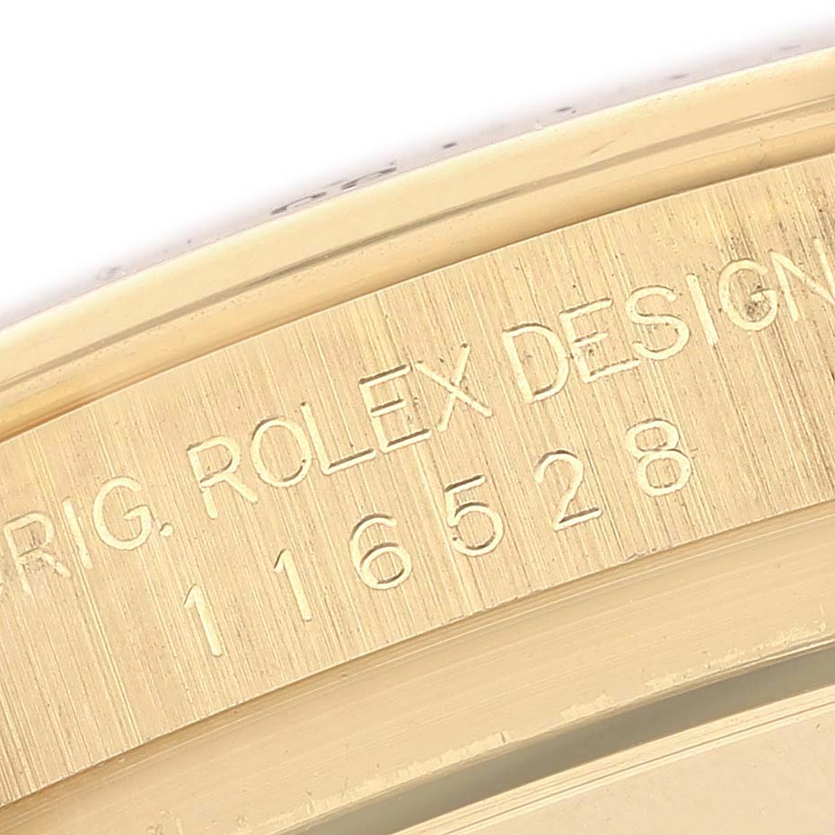 The image shows a close-up of the Rolex Daytona 116528 Men's Yellow Gold Mother of Pearl Dial model's engraved bezel edge.