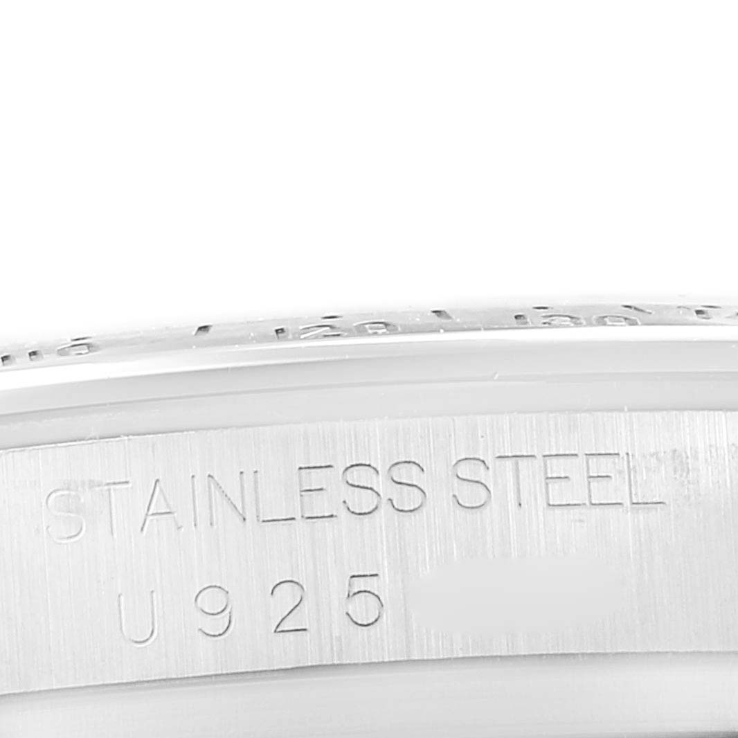 The image shows a close-up of the side of a Rolex Daytona 16520 Men's Stainless Steel Black Dial watch case, highlighting the "Stainless Steel" engraving.
