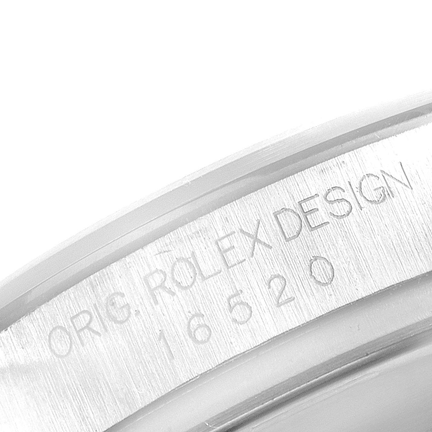 The image shows a close-up of the side of a Rolex Daytona 16520 Men's Stainless Steel Black Dial watch case, displaying engraved text.