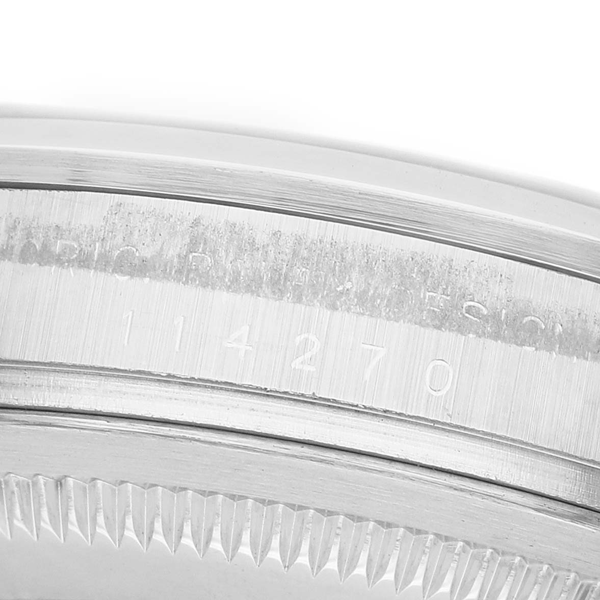 The image shows a close-up of the case side and serial number engraving of a Rolex Explorer 114270 Men's Stainless Steel Black Dial watch.