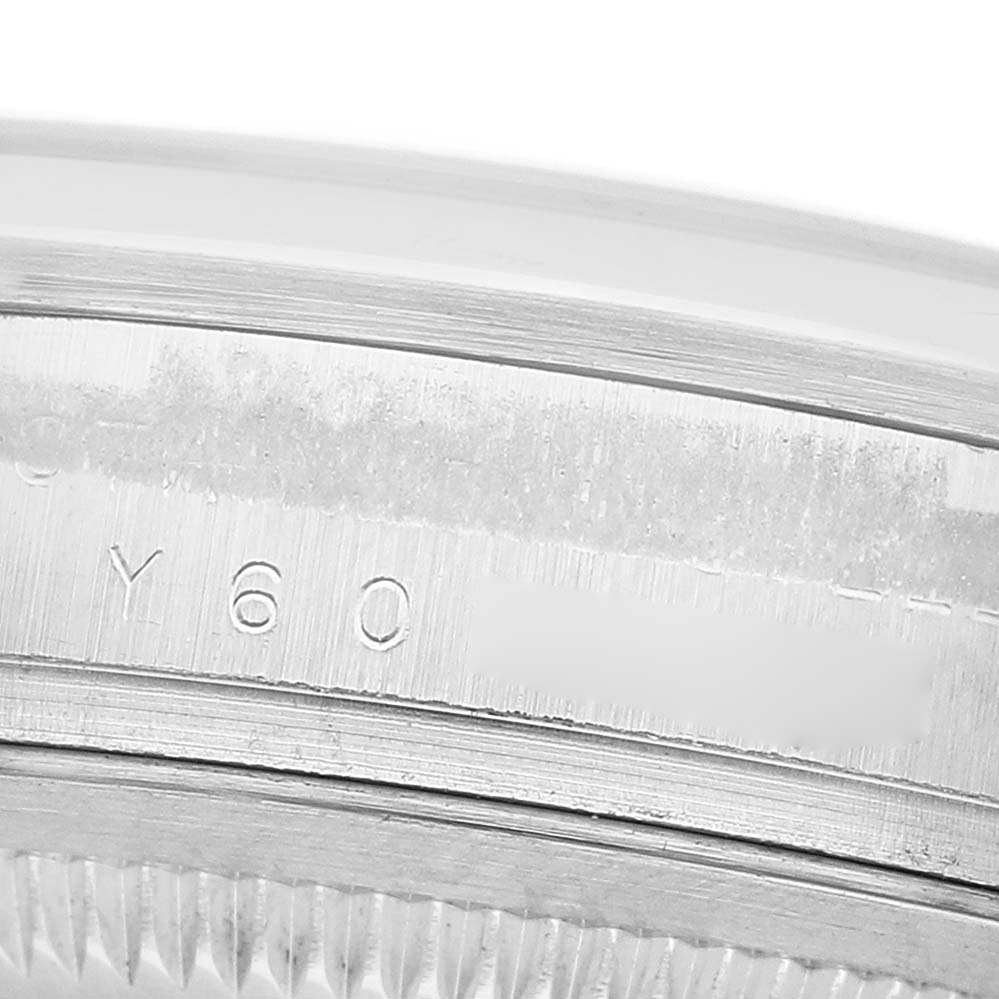 The image shows a close-up of the engraved bezel of a Rolex Explorer 114270 Men's Stainless Steel Black Dial watch.