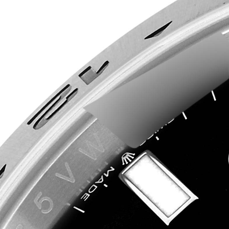 The image shows a close-up of the bezel and part of the dial for the Rolex Explorer Men's Stainless Steel Black Dial Men's Stainless Steel Black Dial watch, highlighting the branding and markers.