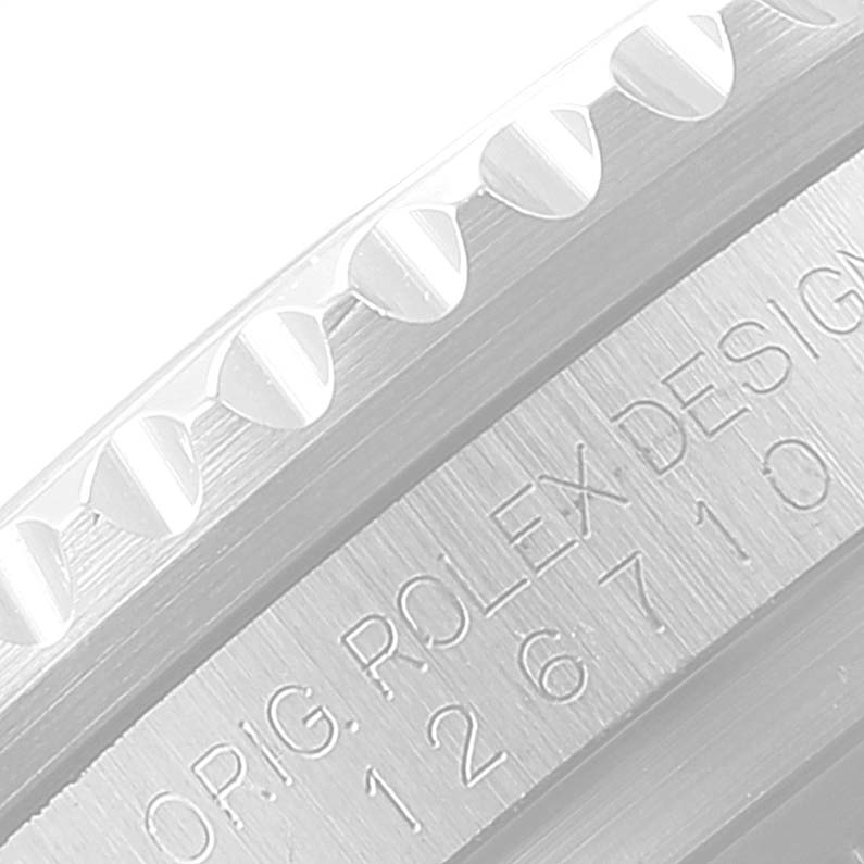 This close-up image of a Rolex GMT-Master 116710 Men
s Stainless Steel Black Dial 116710 Men
s Stainless Steel Black Dial watch shows part of the bezel and engraved text on the watch case.