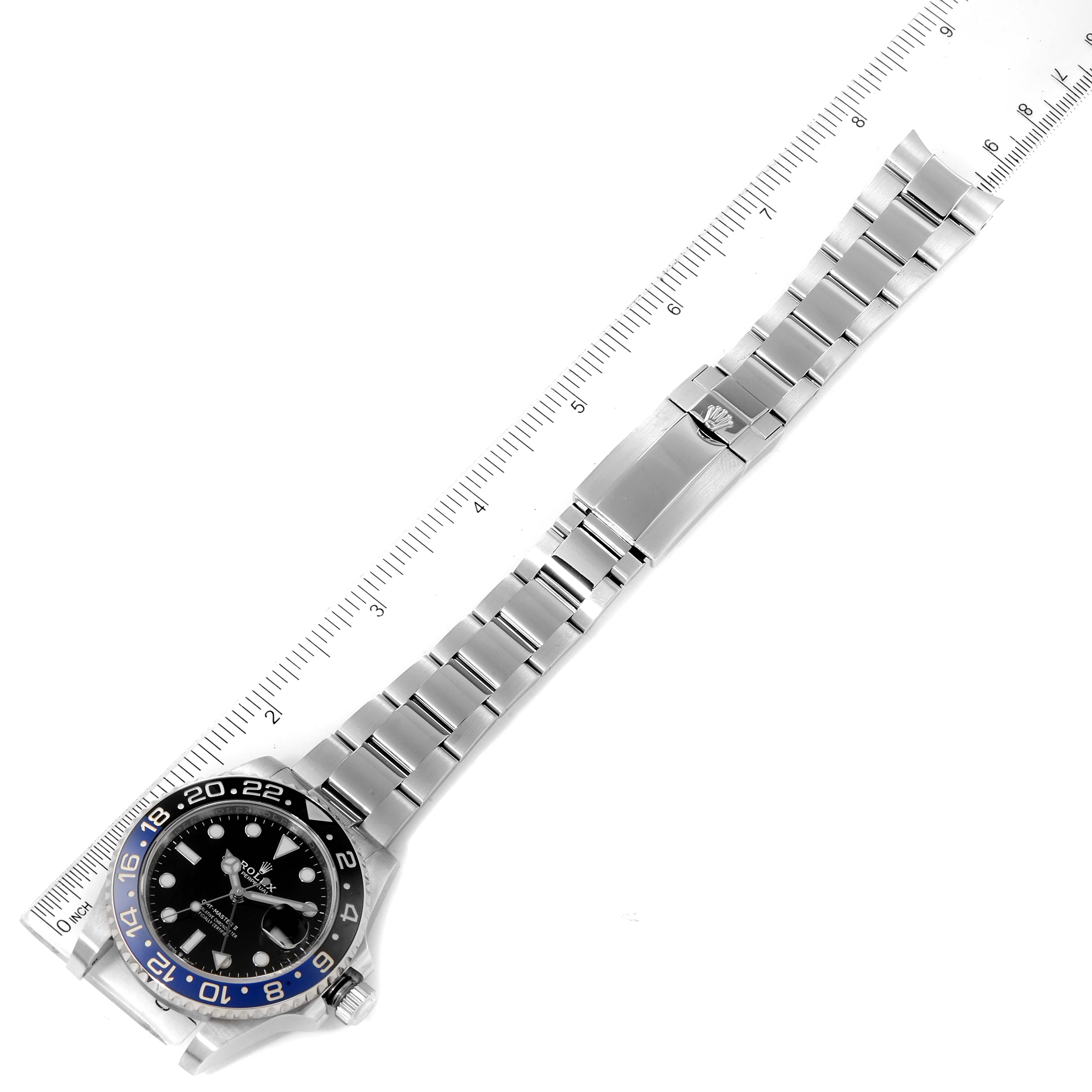 The image shows a Rolex GMT-Master 116710 Men
s Stainless Steel Black Dial 116710 Men
s Stainless Steel Black Dial watch laid flat with the dial and full bracelet extended, alongside a ruler for scale.