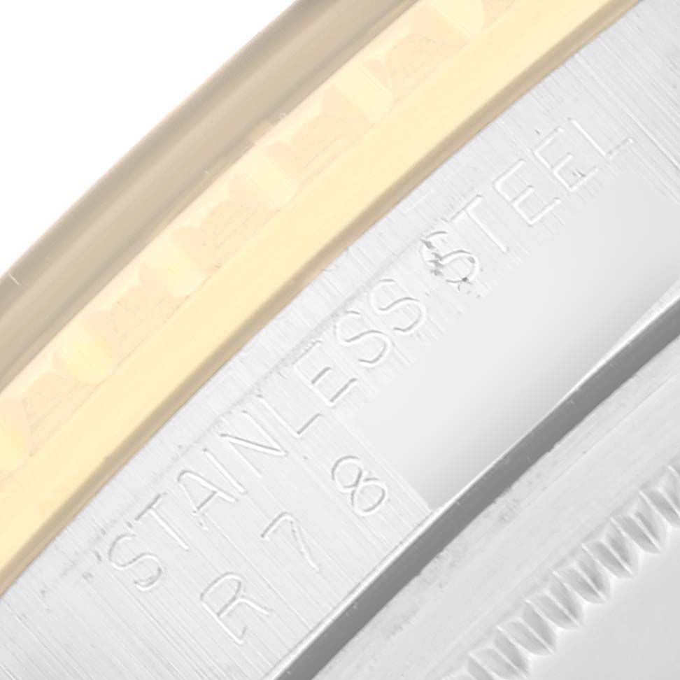 This close-up image of a Rolex GMT-Master 16753 Men's Stainless Steel Black Dial 16753 Men's Stainless Steel Black Dial shows the edge of the watch case with "STAINLESS STEEL" engraved on it.