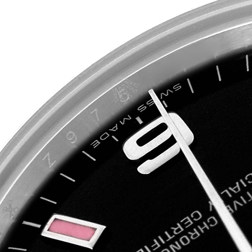 The image shows a close-up angle of the Mid-Size Rolex watch dial, revealing part of the number "9," the minute hand, and "Swiss Made."