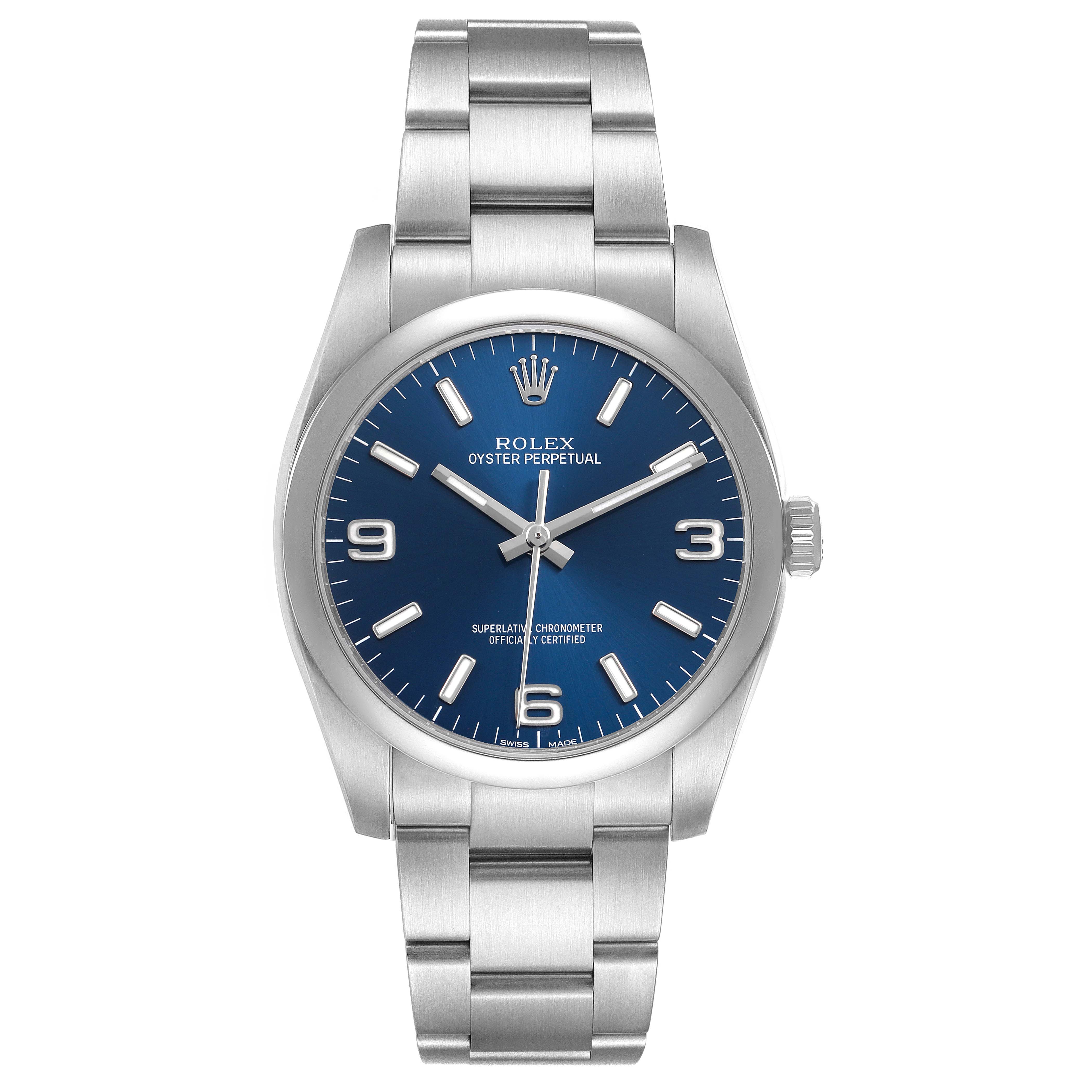 The Rolex Oyster Perpetual 116000 Men's Stainless Steel Blue Dial watch is shown from a front angle, displaying the blue dial and stainless steel bracelet.