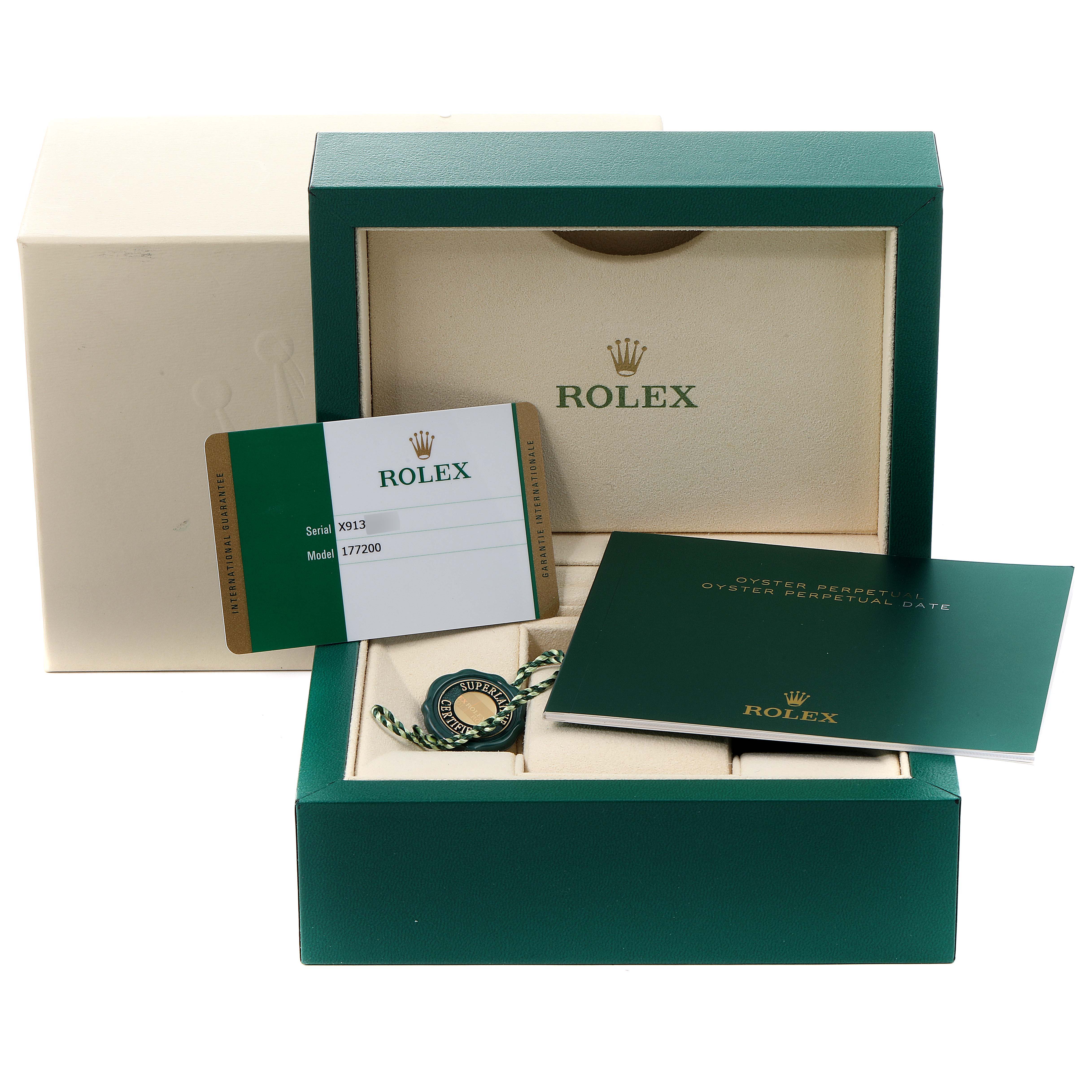 The image shows a green Rolex box containing accessories for the Rolex Mid-Size 177200 Women's Stainless Steel Burgundy Dial 177200 Women's Stainless Steel Burgundy Dial model, including paperwork and a tag.